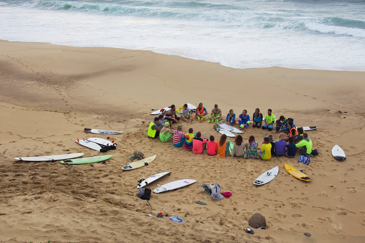 Fluoro Fridays start with a 5-10 minute chat on the sand before the surfing and yoga get underway, Everyone's invited to share something, but we mostly just listen.