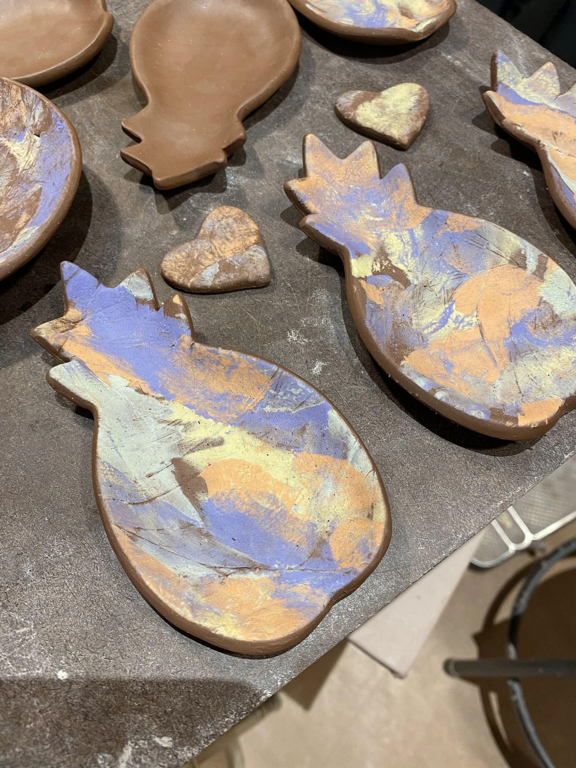 Slip-decorated pineapple dishes before firing · colored slip on stoneware