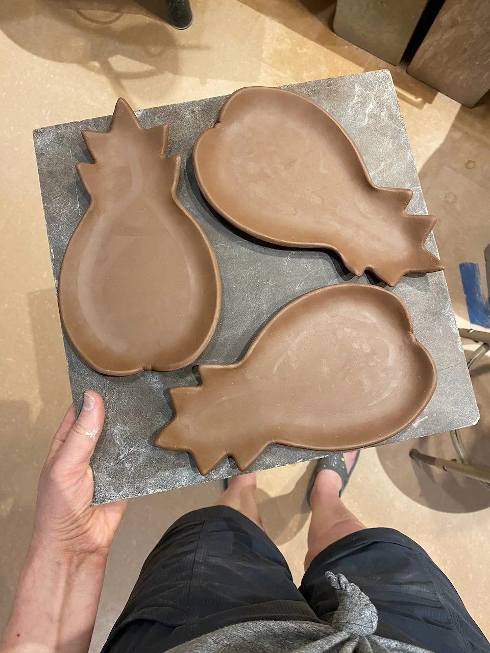 Pineapple dishes on a bat, greenware · stoneware