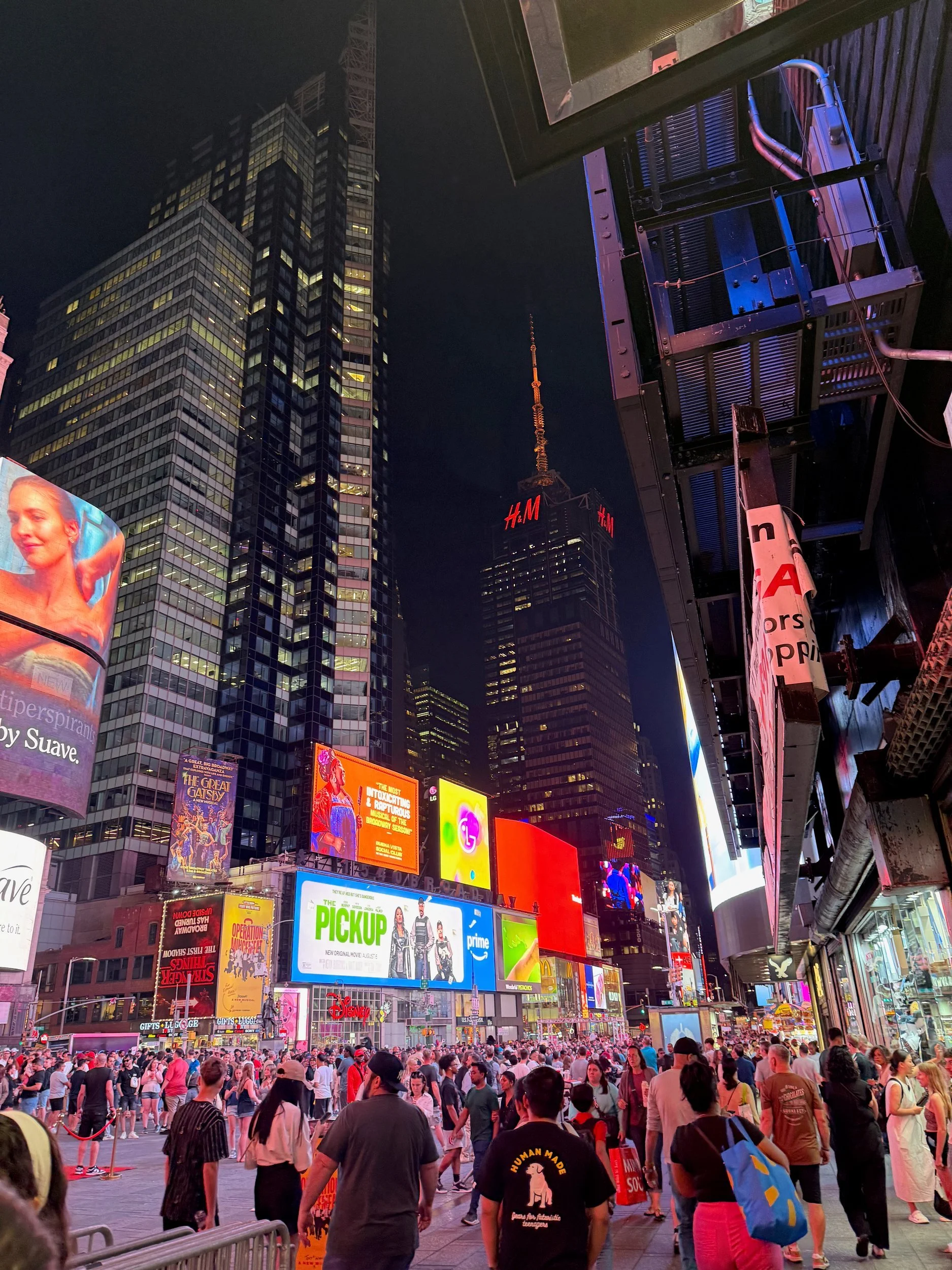 Crowds and neon billboards in Times Square at night, New York City