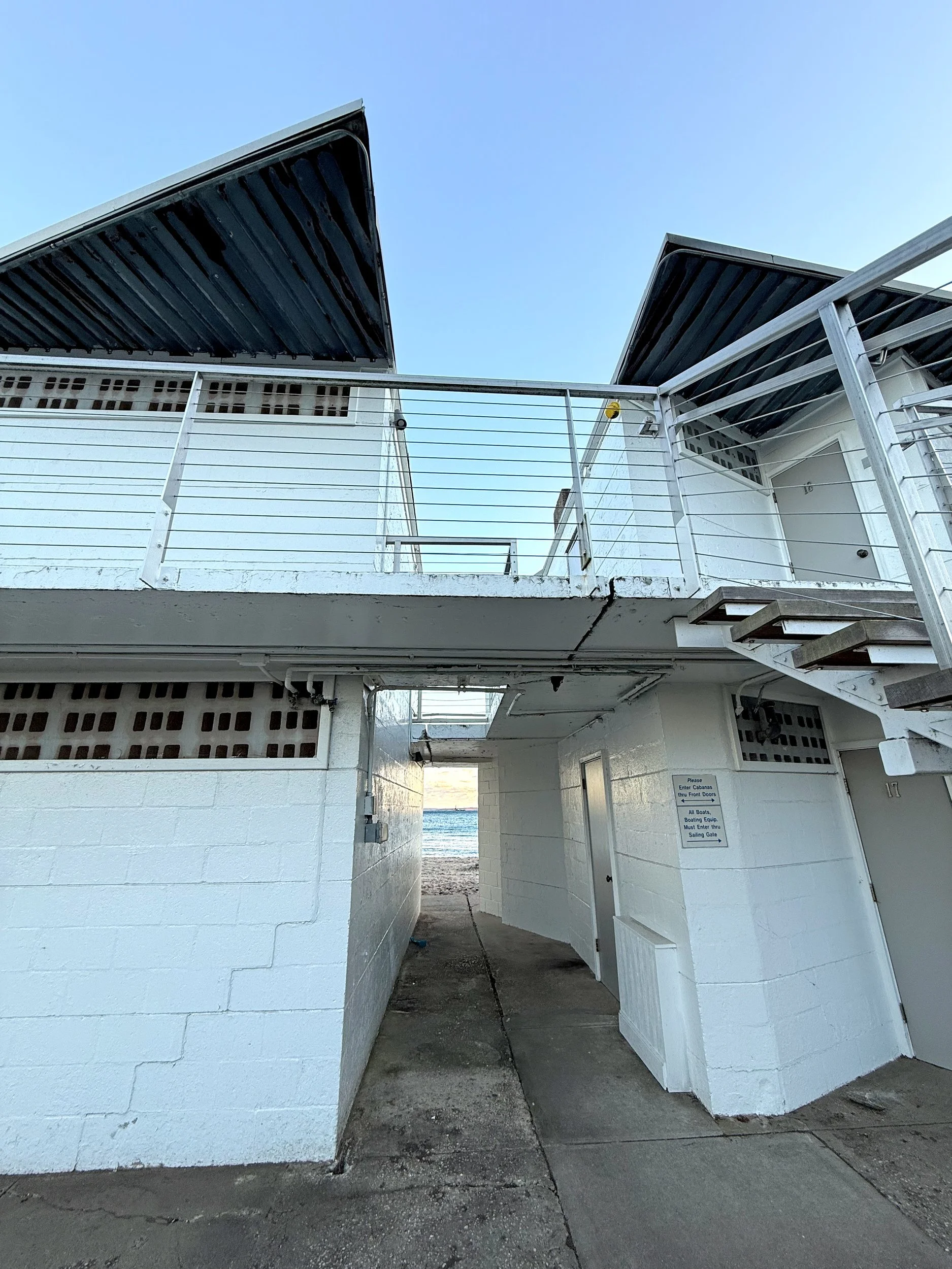 White Tokeneke beach club building with hard shadows and angled roofs
