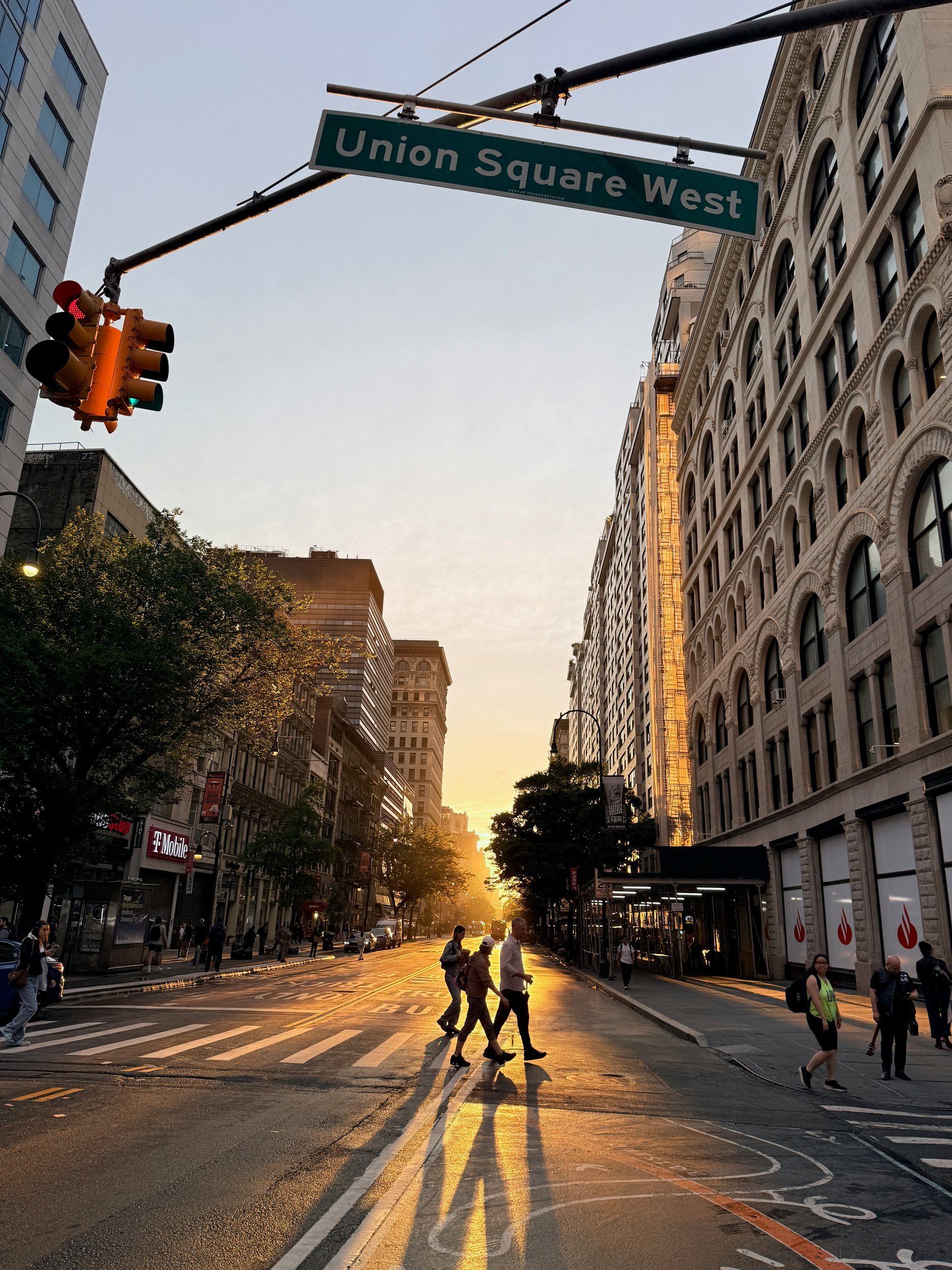Sunset down Union Square West with walkers in long shadows, New York City