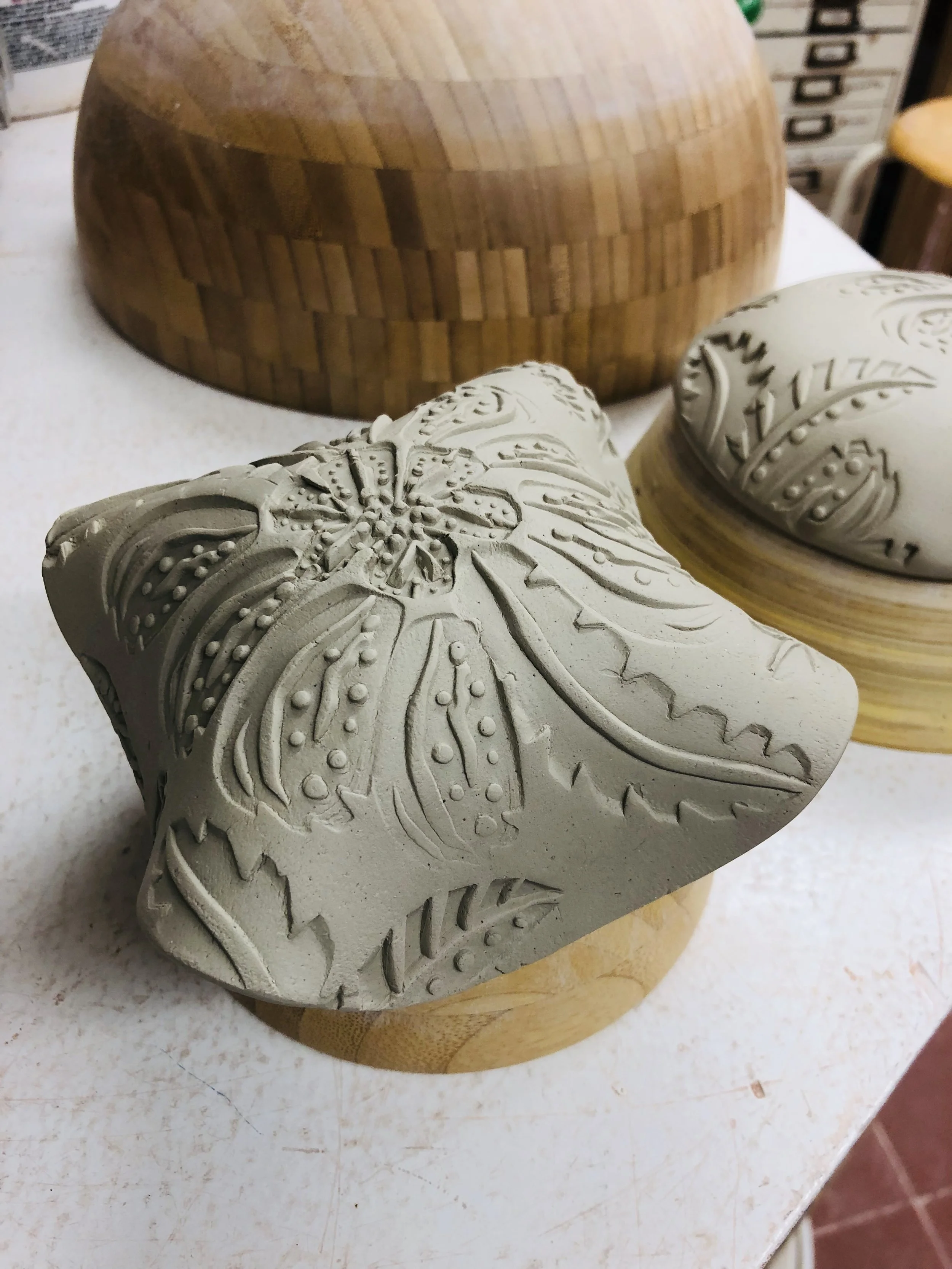 Textured slab draped over a hump mold