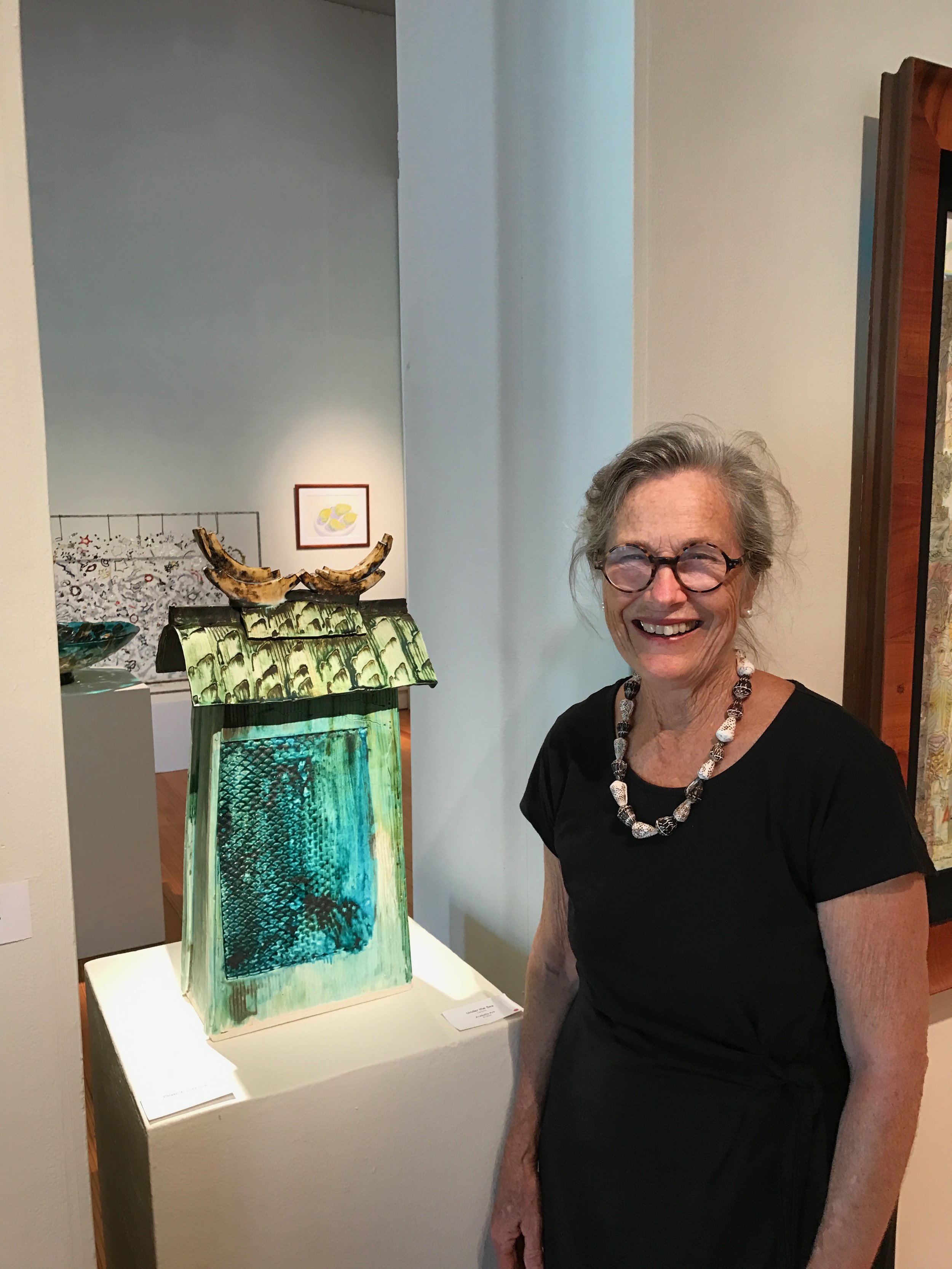 Maui Crafts Guild member AraBella Ark at the opening of the new ArtMAUI 2107next to her entry that was accepted and sold. 