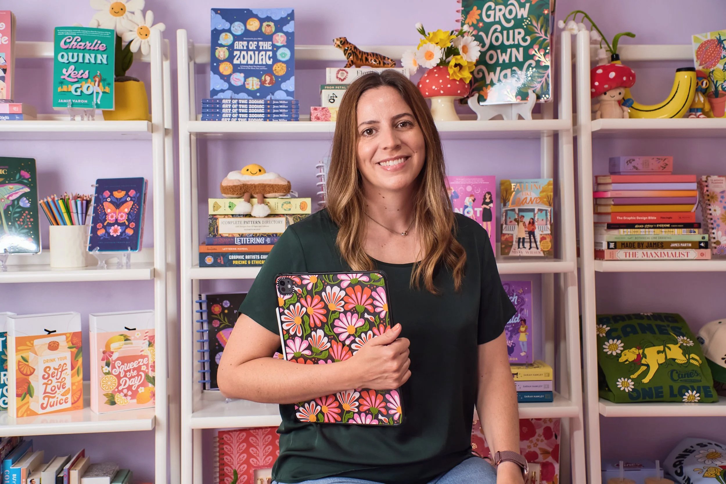 jess miller in front of shelves with her art