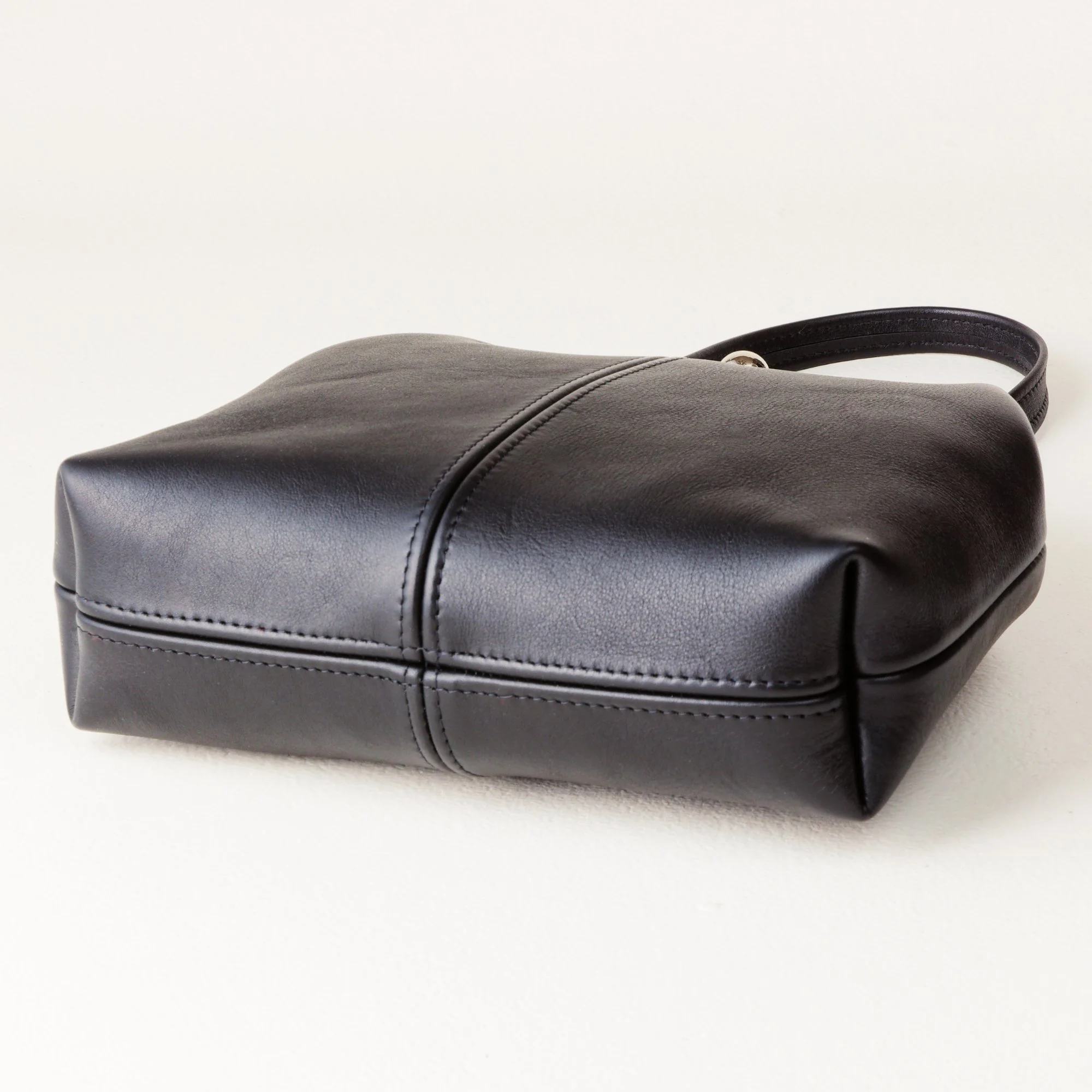 Bottom Shot of 8 inch Kiss Lock Bag on Tabletop
