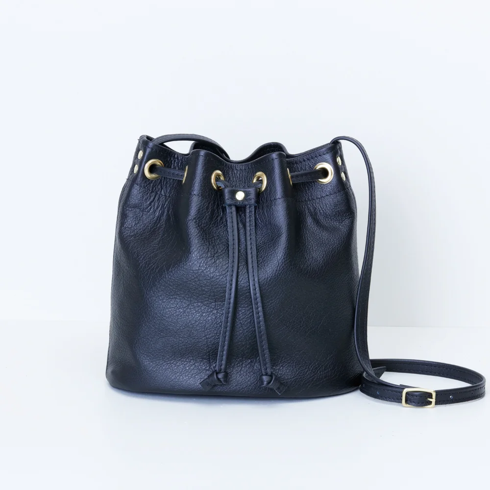 Black Cross Body Bucket Bag Table.jpg
