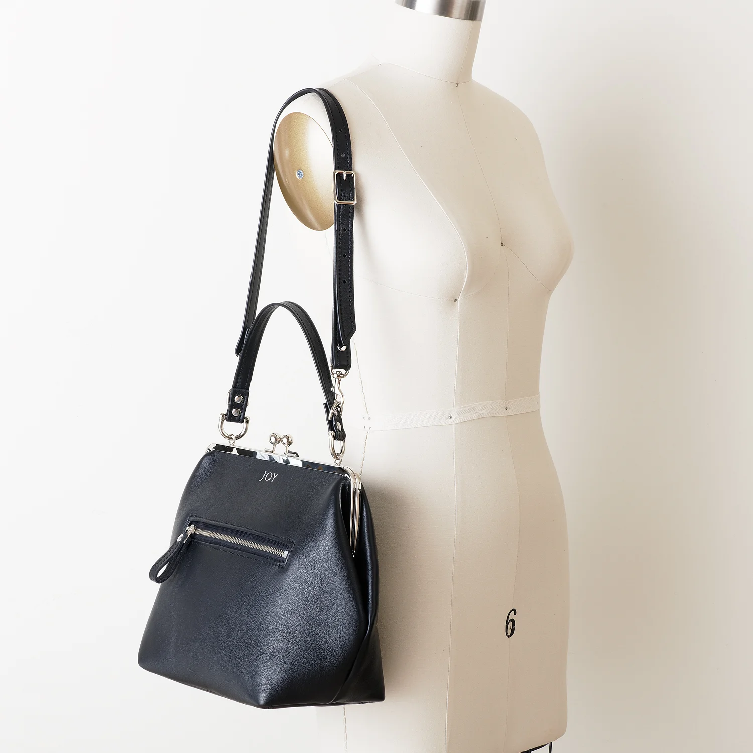 NEW Black Leather Kiss Lock Backpack on Shoulder Angled with Mongram.jpg