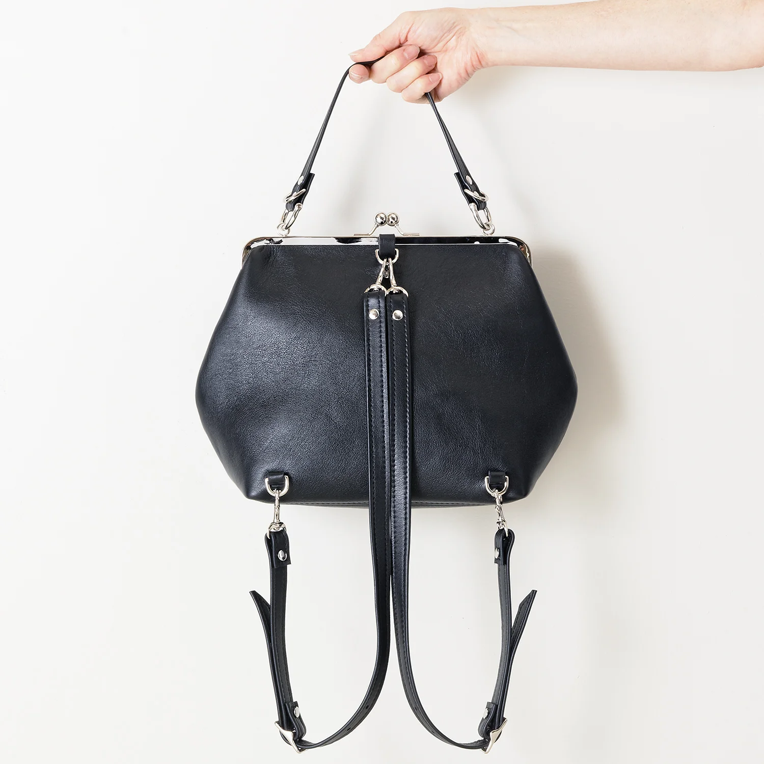 NEW Black Leather Kiss Lock Backpack in Hand Back.jpg