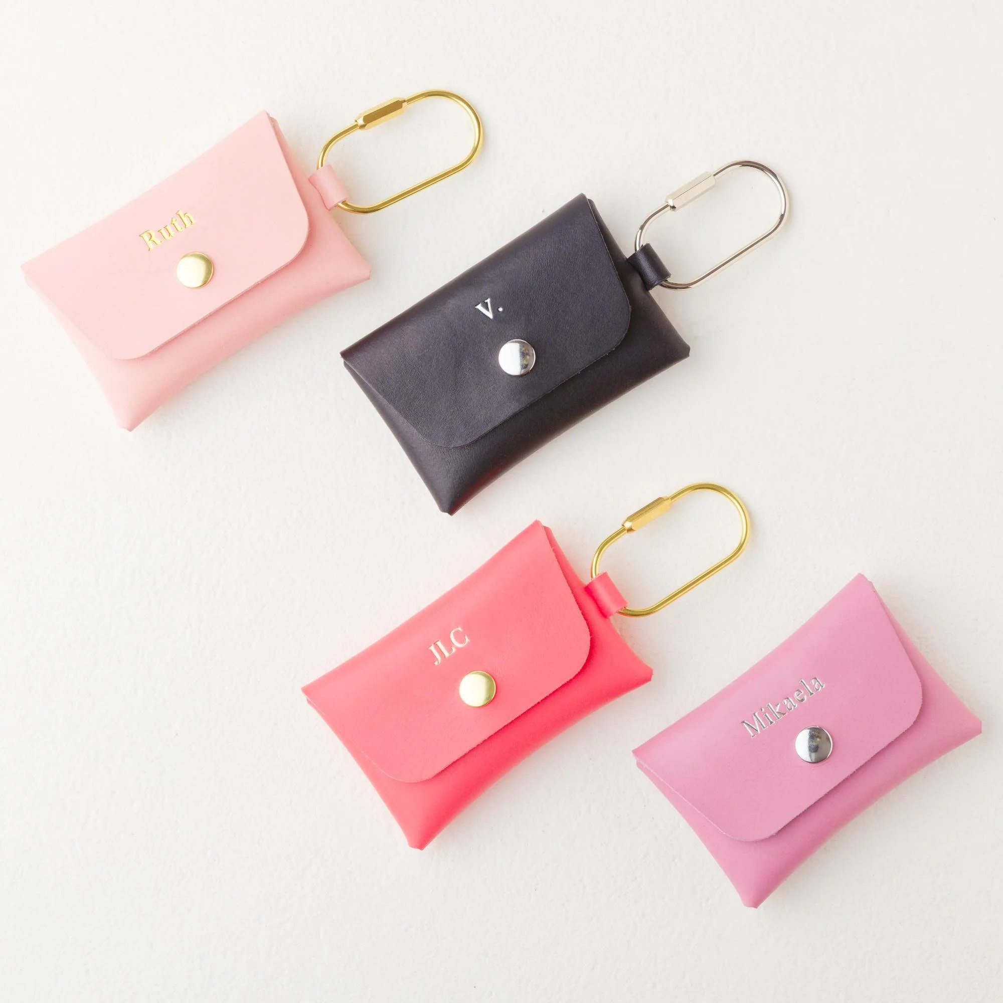 Set of four personalized leather carabiner keychain wallet pouch / purse charms. Colors include pink, black, purple and coral.