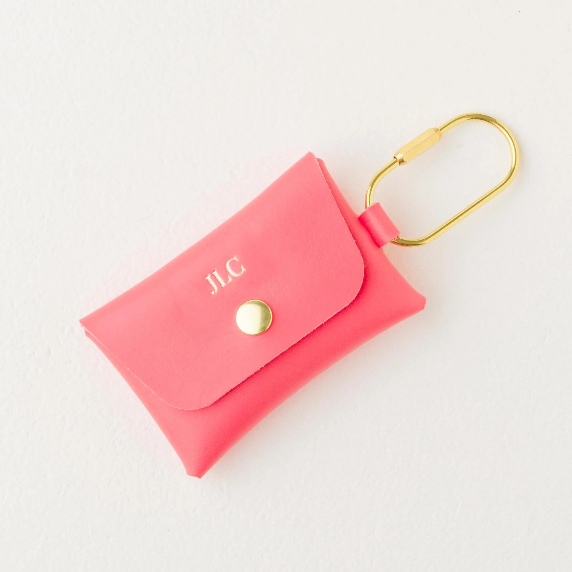 Personalized coral color leather carabiner keychain wallet / purse charm with gold finish hardware and rose gold foil monogram.