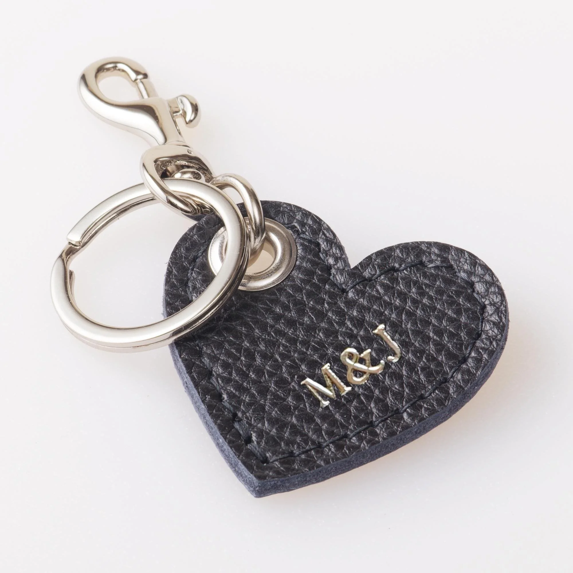 Personalized black leather heart shaped keychain with silver finish hardware.