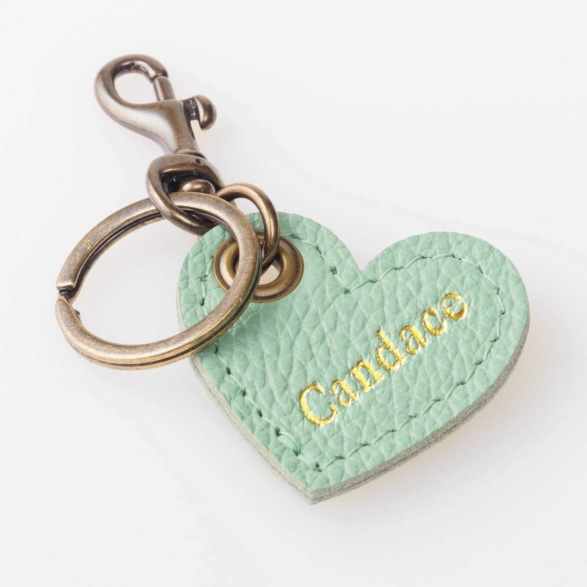 Personalized green leather heart shaped keychain with antique brass finish hardware.