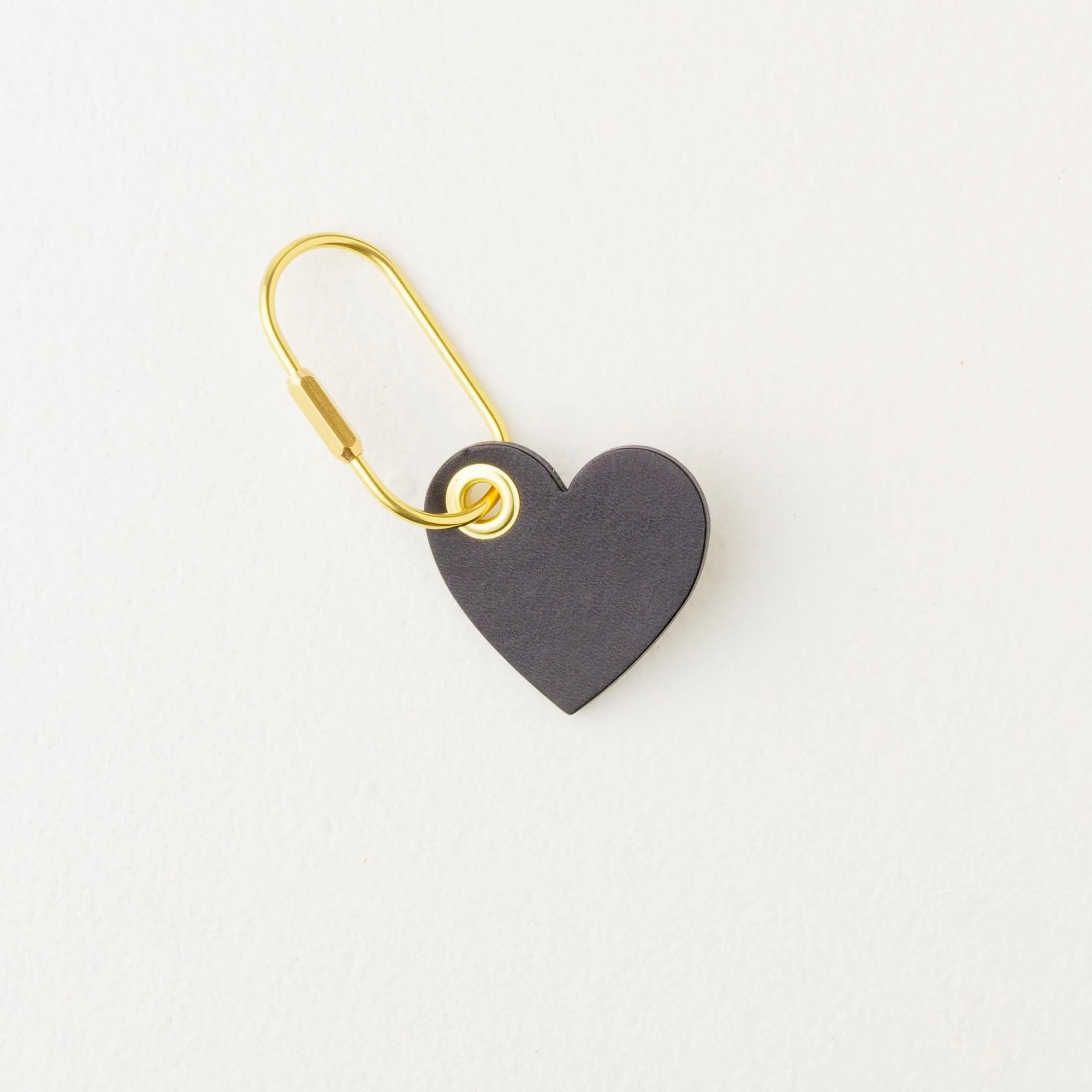 Black heart shaped leather purse charm / keychain with gold finish hardware.