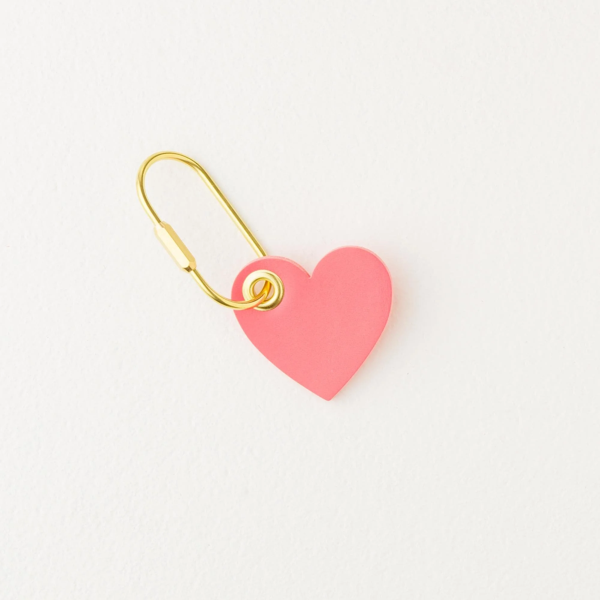 Coral color heart shaped leather purse charm / keychain with gold finish hardware.