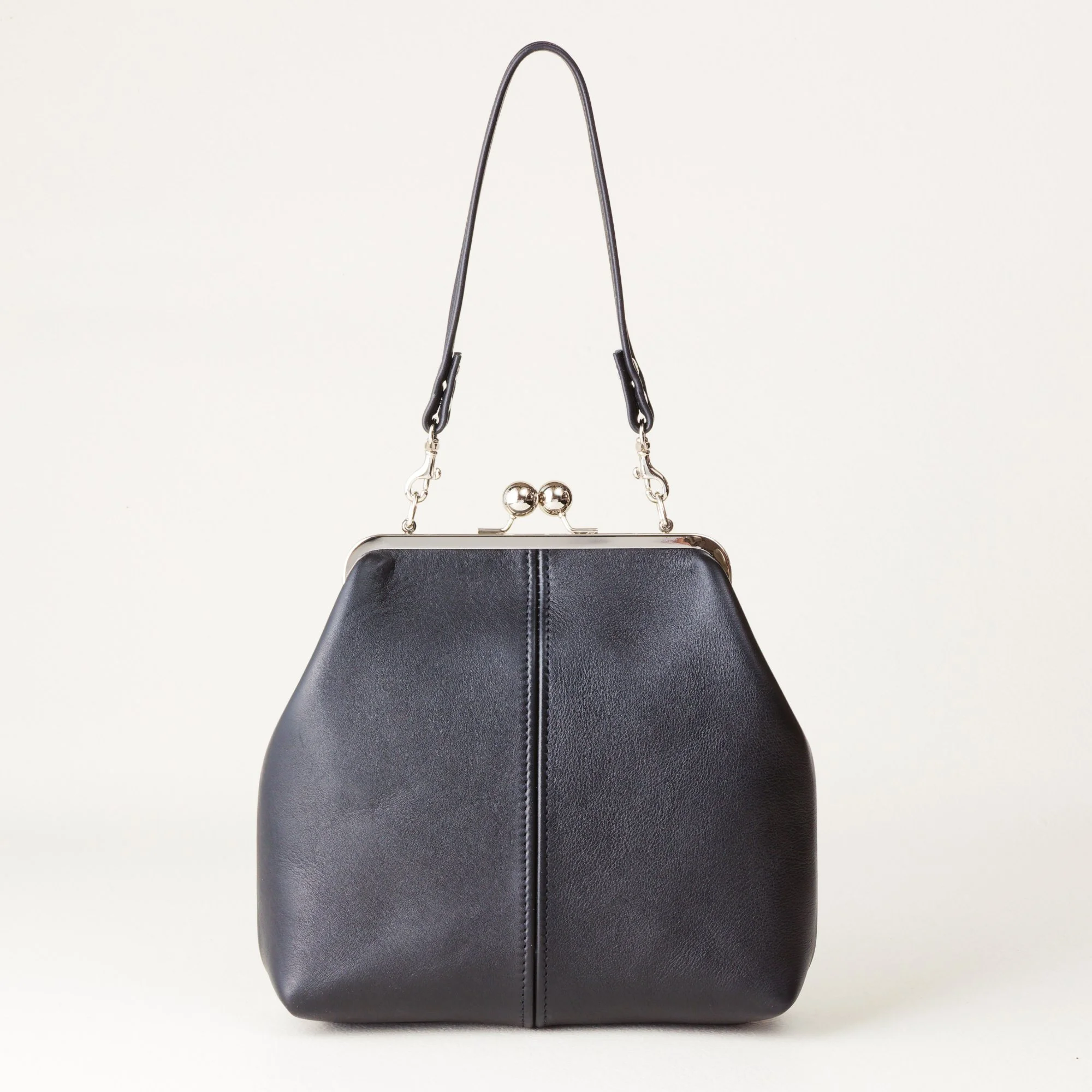 Shorty Strap 8 inch Kiss Lock Handbag on Tabletop