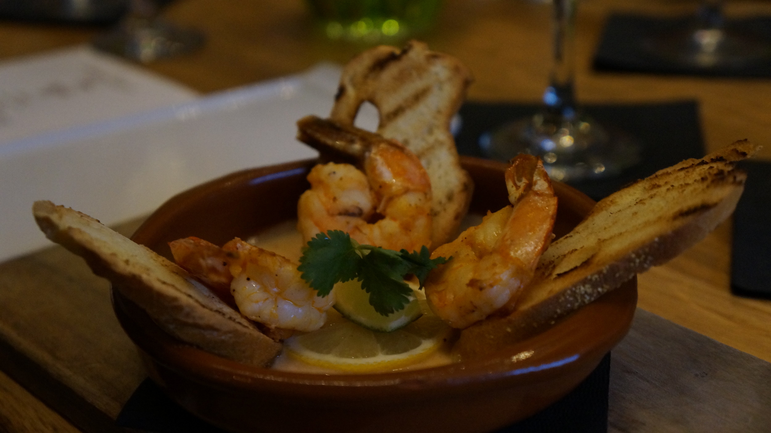 Shrimp a la Plancha : La Plancha is a reference to a griddle or a grill that we use to cook the shrimp. This simple shrimp dish is elevated to new heights by using Kasa’s house made coconut red curry sauce with lime and butter.