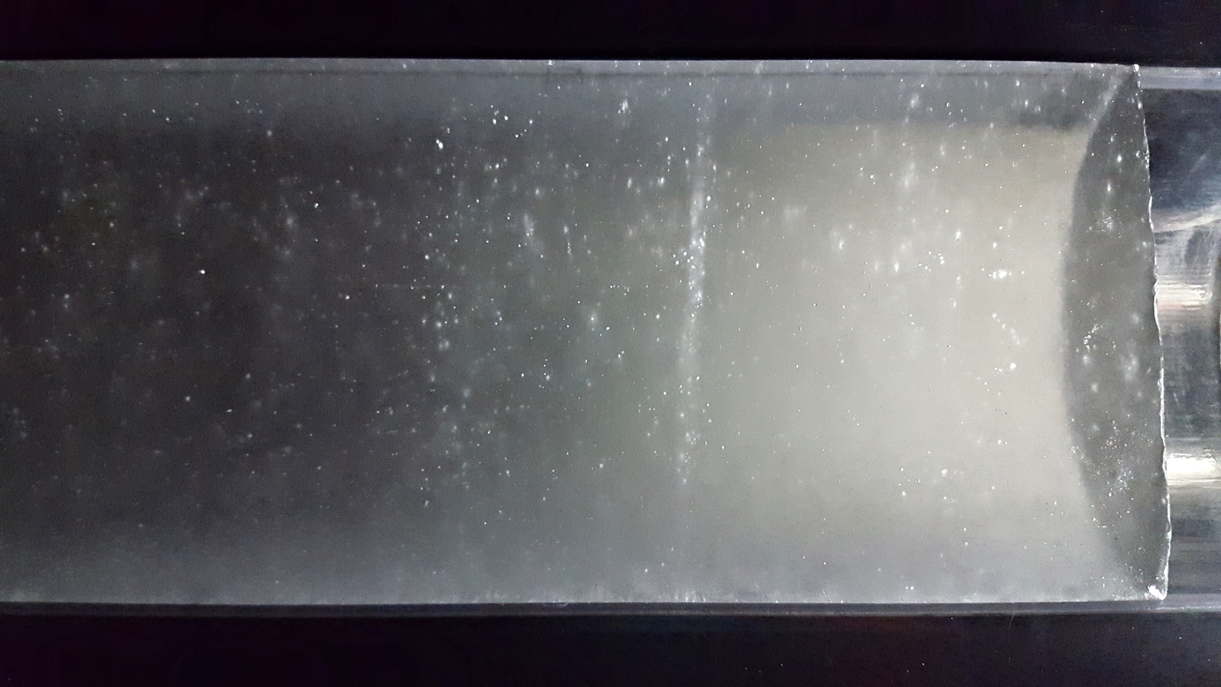A deep ice core from West Antarctica in raking light. Note the line of bubbles, which are gases exsolving from the ice due to decompression, not unlike when you open a bottle of pop.