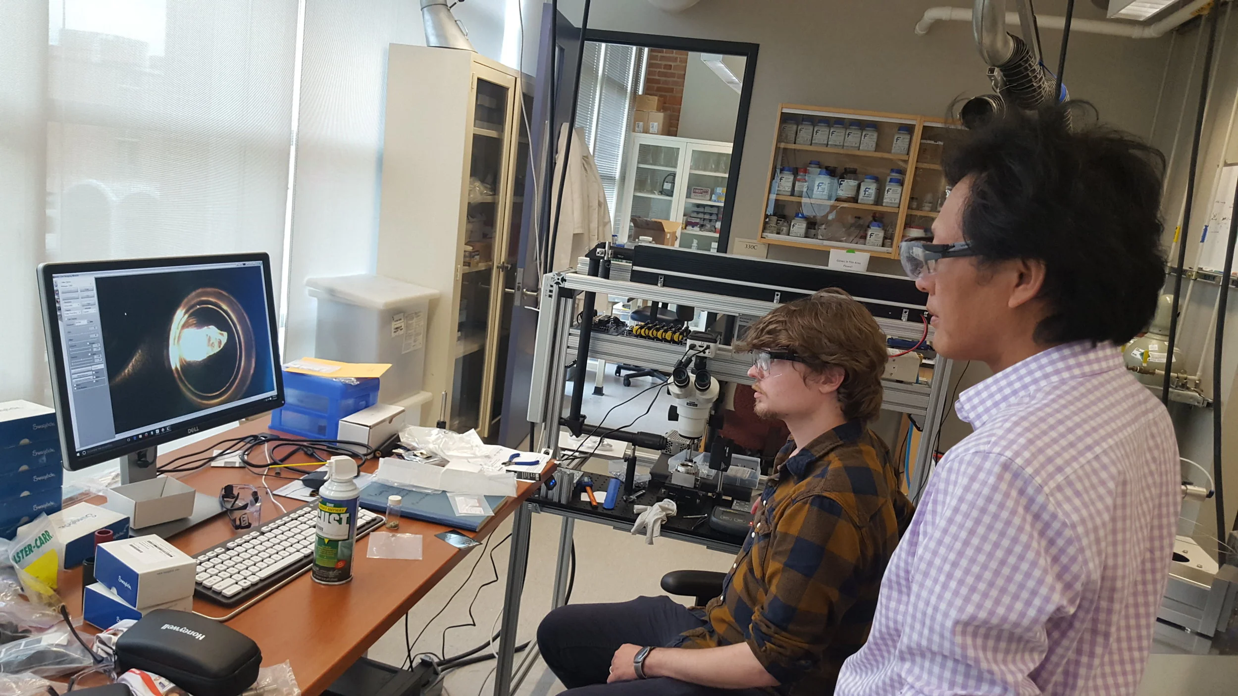 Justin operating the laser-fluorination line (Cin-Ty looking on) to extract oxygen from minerals for isotopic analysis. Justin uses the oxygen to learn about ancient environments.