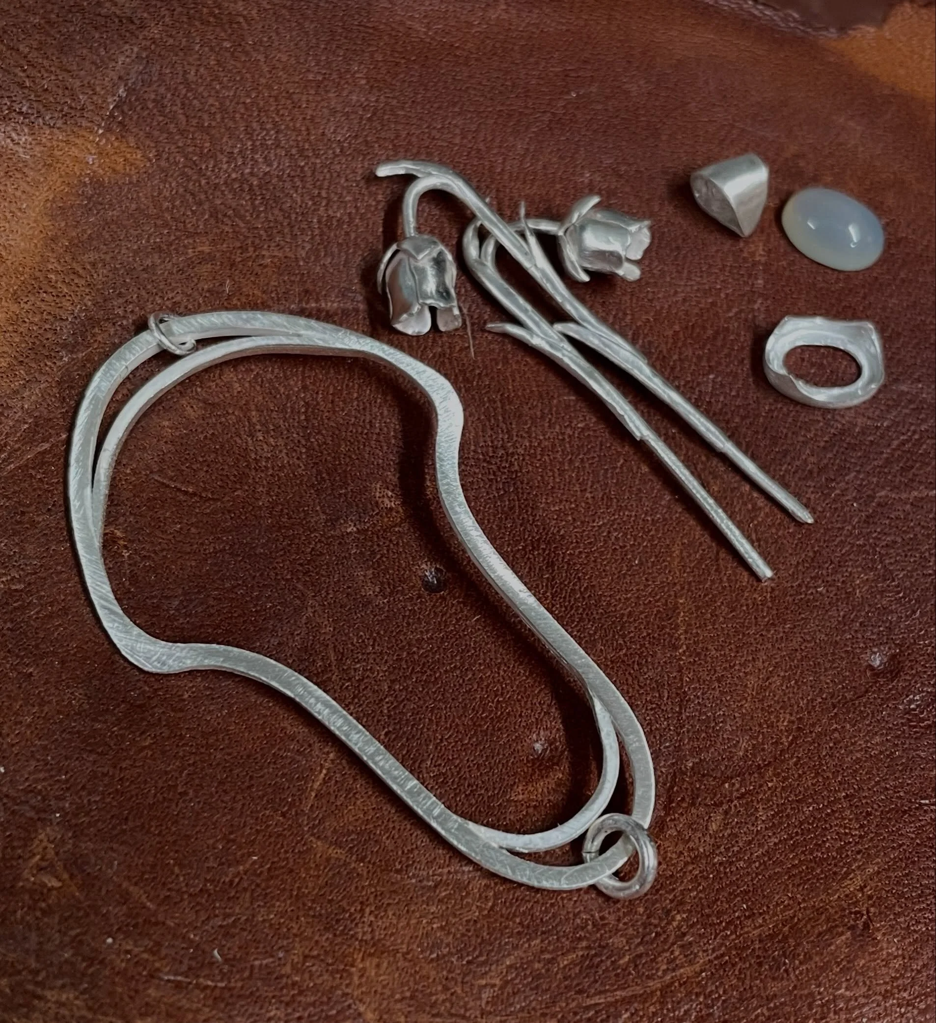 Assembling all the little pieces for the ghost pipe pendant. I had a really hard time figuring out what stone to use for this piece, but ultimately picked a little grey-toned chalcedony. It has the milky/glowy consistency I really love. Final solderi