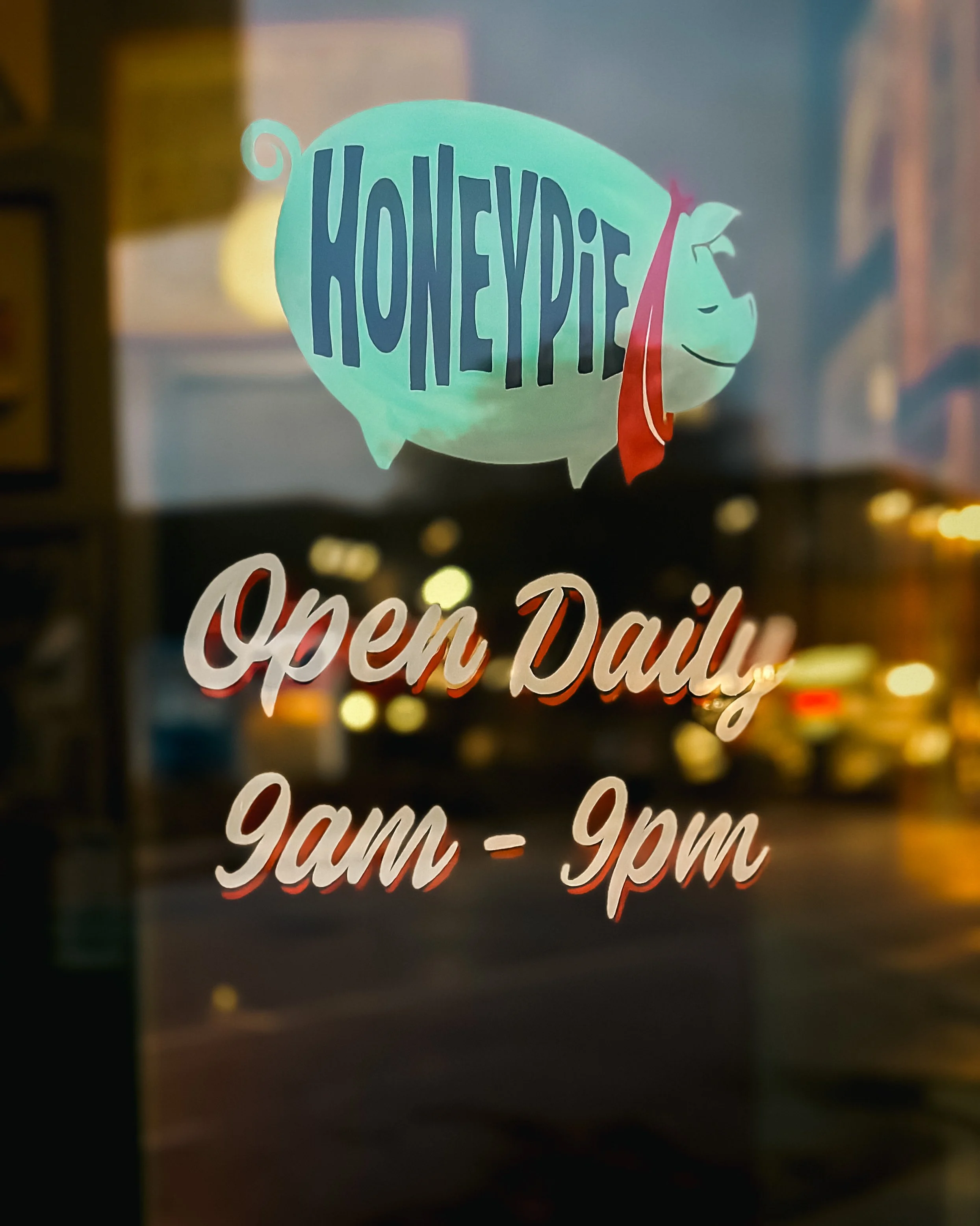 Honeypie hours in paint on the door at Honeypie Cafe.