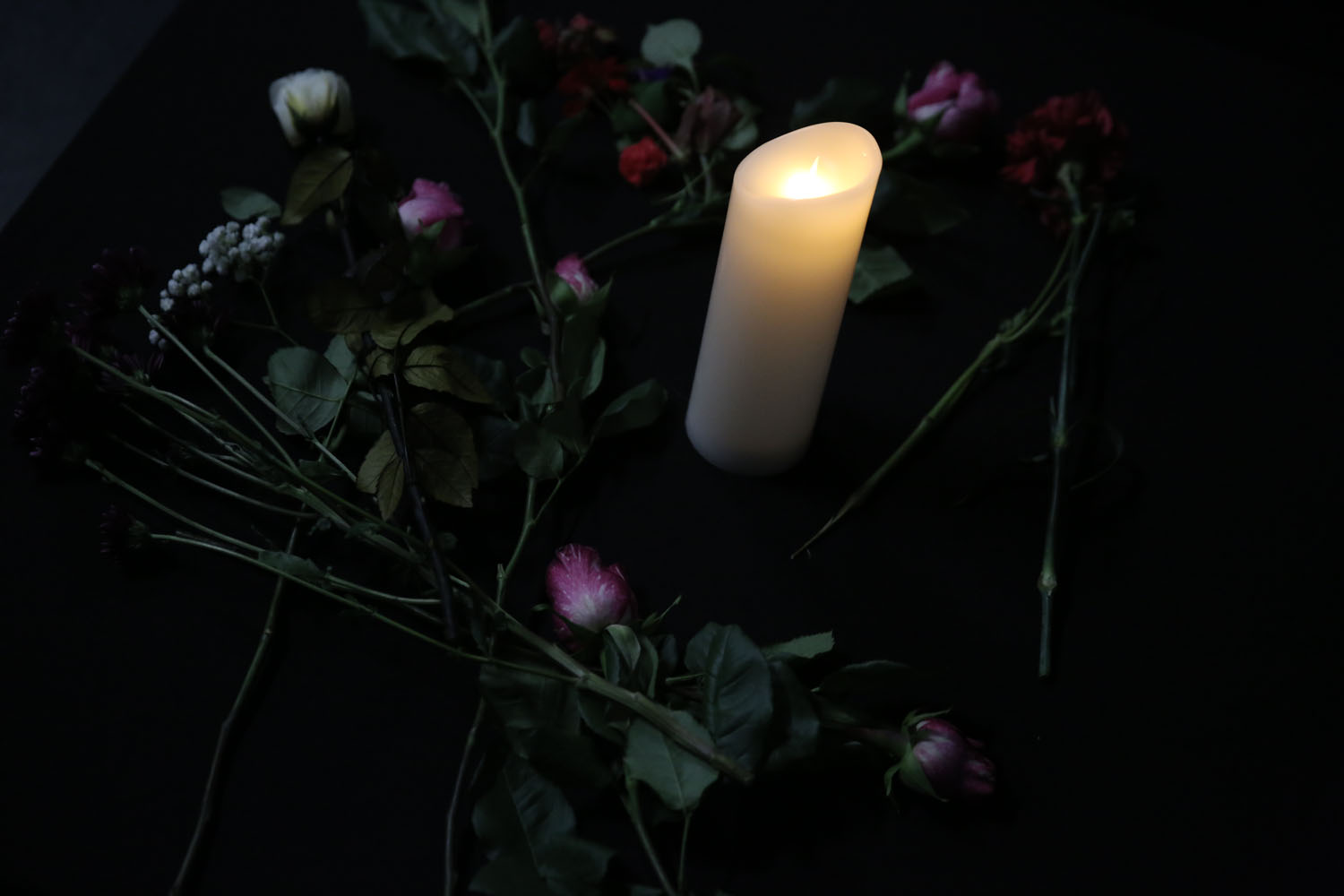 a candle and flowers