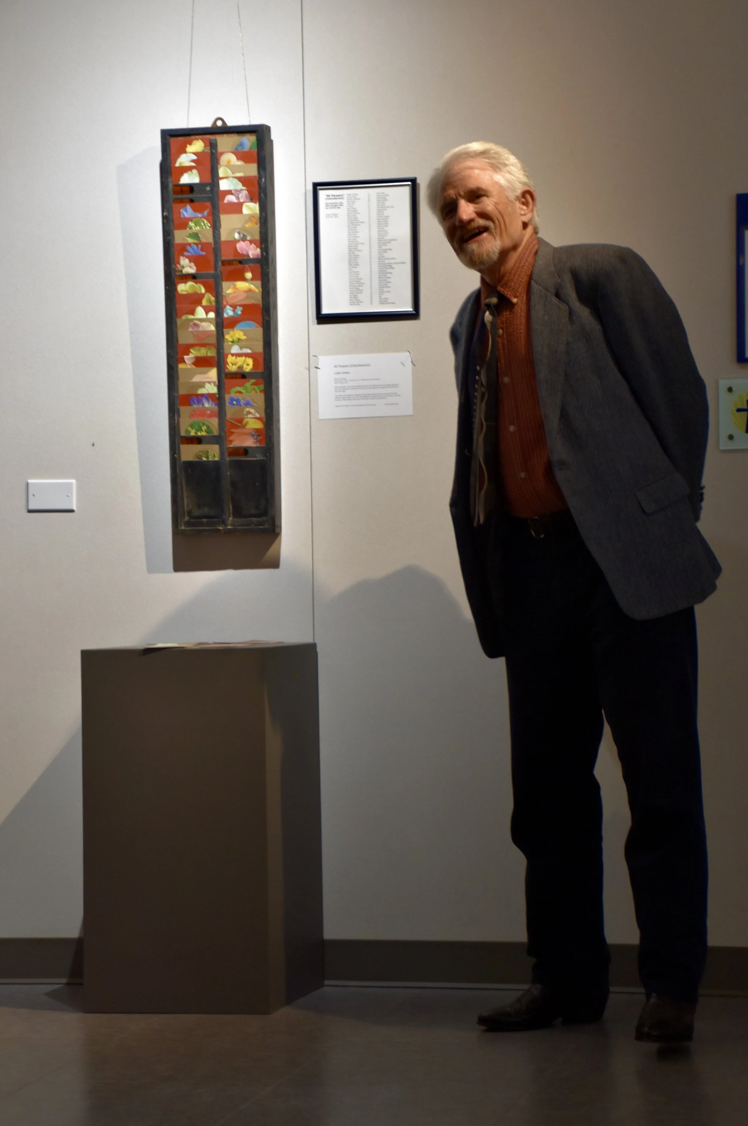 Leslie Caldera with timecard collage portraits of musicians who died early.