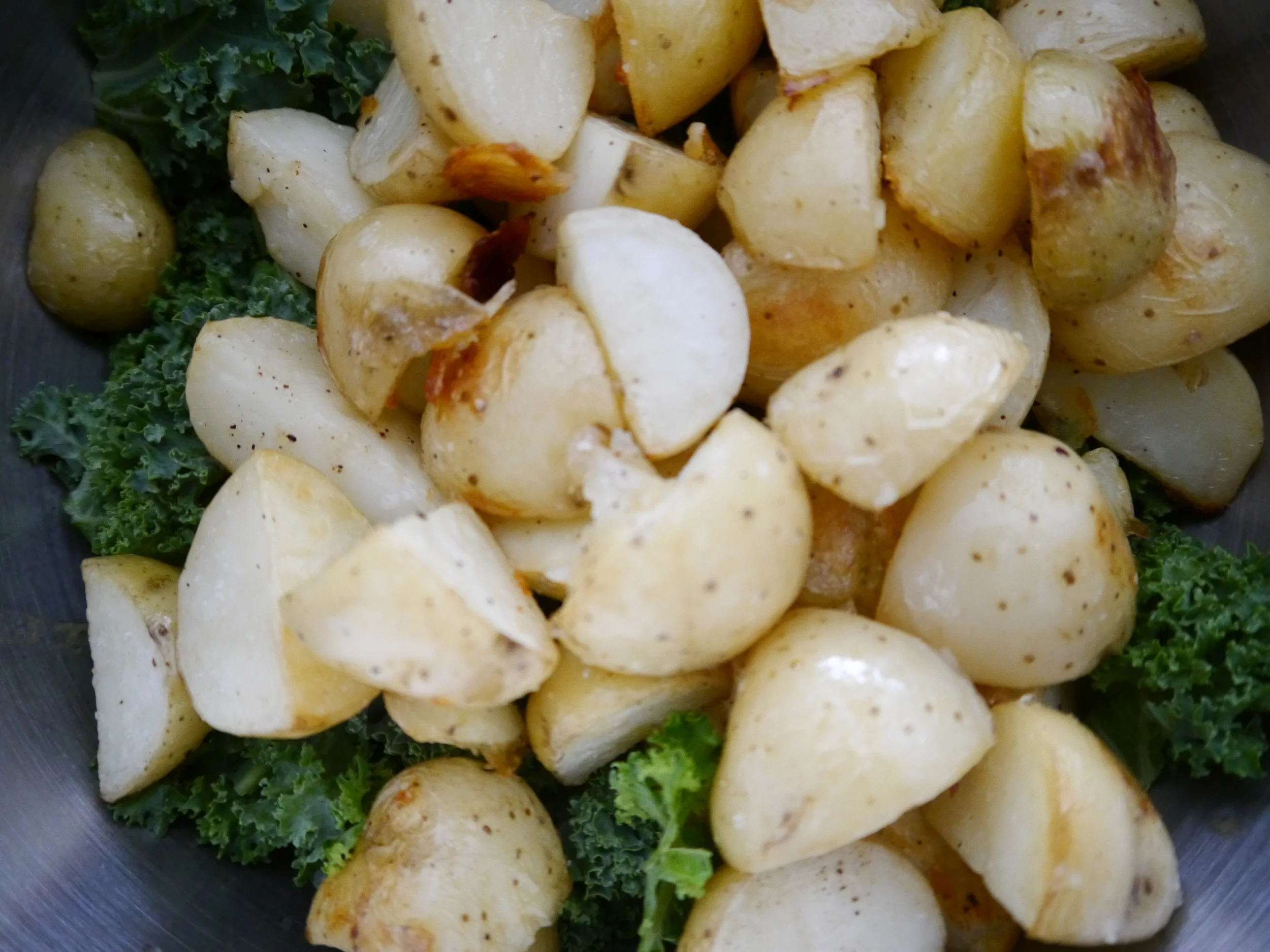 I put the chopped kale in the bowl with the dressing and added the potatoes straight from the oven so that the heat would wilt the greens just a little. Then I mixed the kale and potatoes until they were evenly coated with dressing before addng the lentils and parsley . 