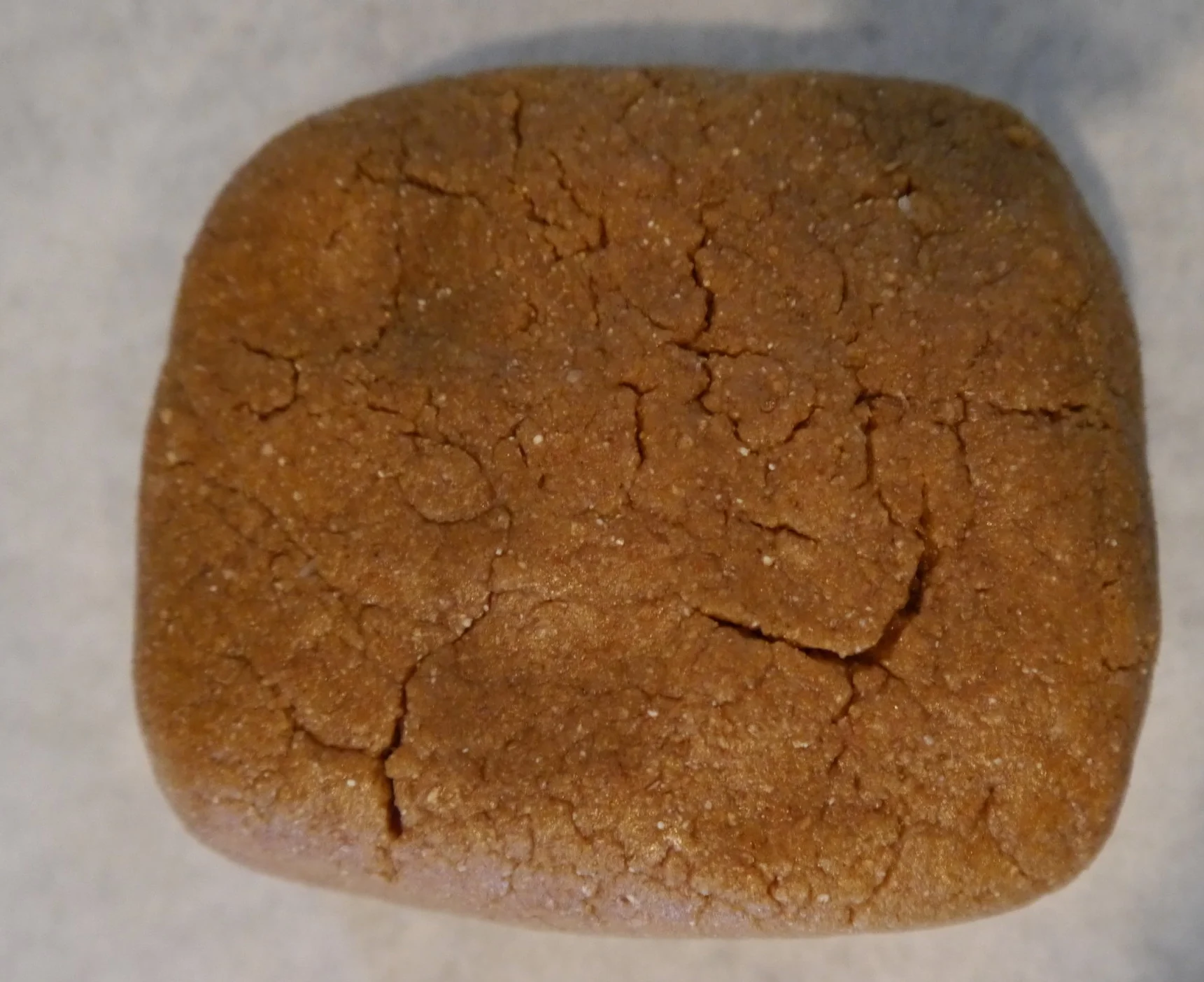 Position a rack in the center of the oven and preheat to 350°F. Place dough on a large piece of parchment paper and pat into a rectangle.