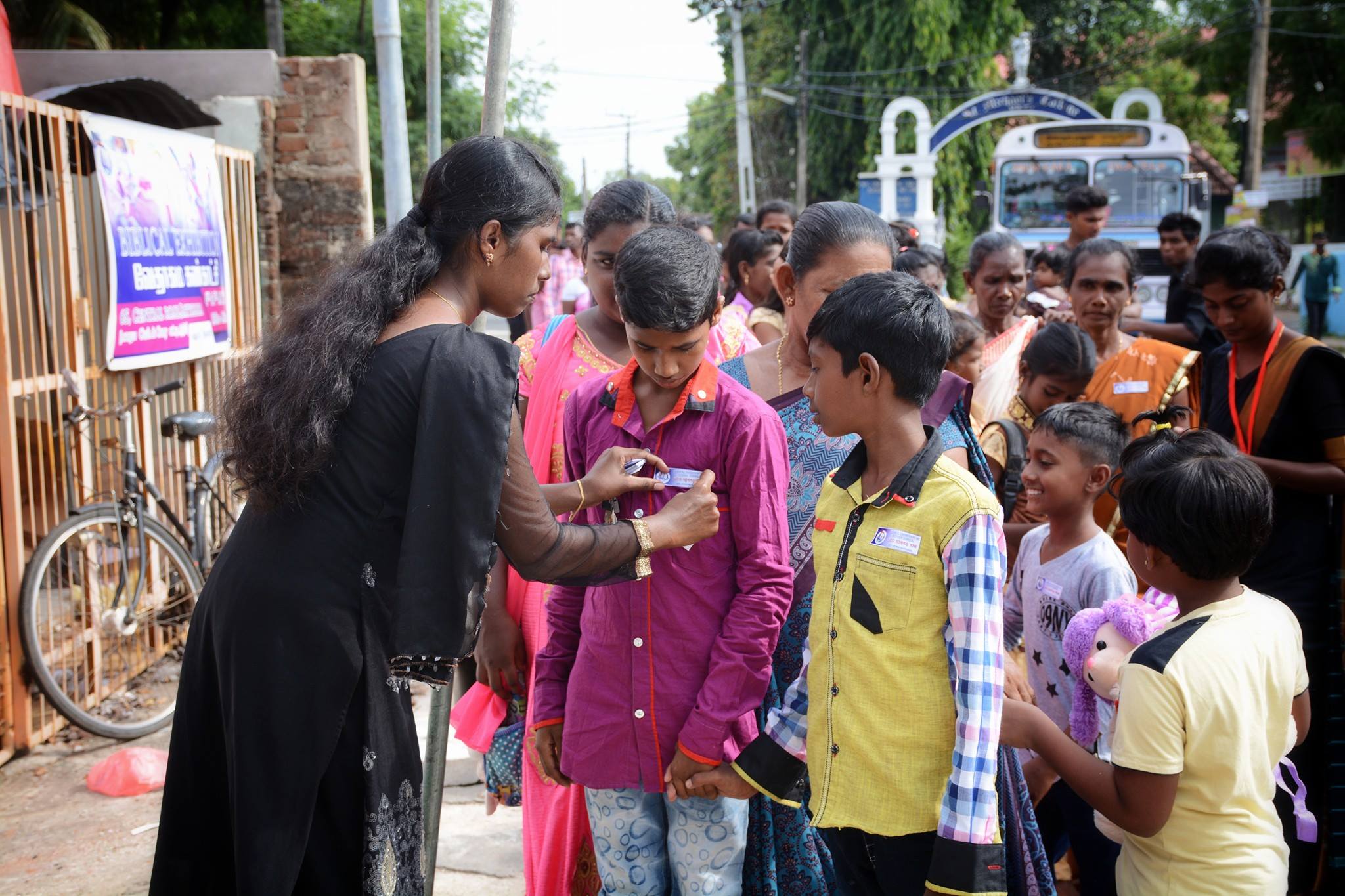 A volunteer places name tags on children during a community event last year at Zion Church in Batticaloa, Sri Lanka. Zion Church was the site of one of Sunday’s bombings, which claimed the life of 290 people overall. (facebook/Zion Church Batticaloa Sri Lanka)