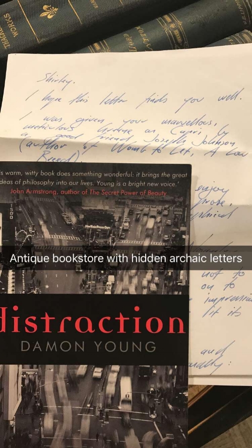 a handwritten letter in an envelope dated 2009, a correspondence with the author Damon Young to another author about his work. 