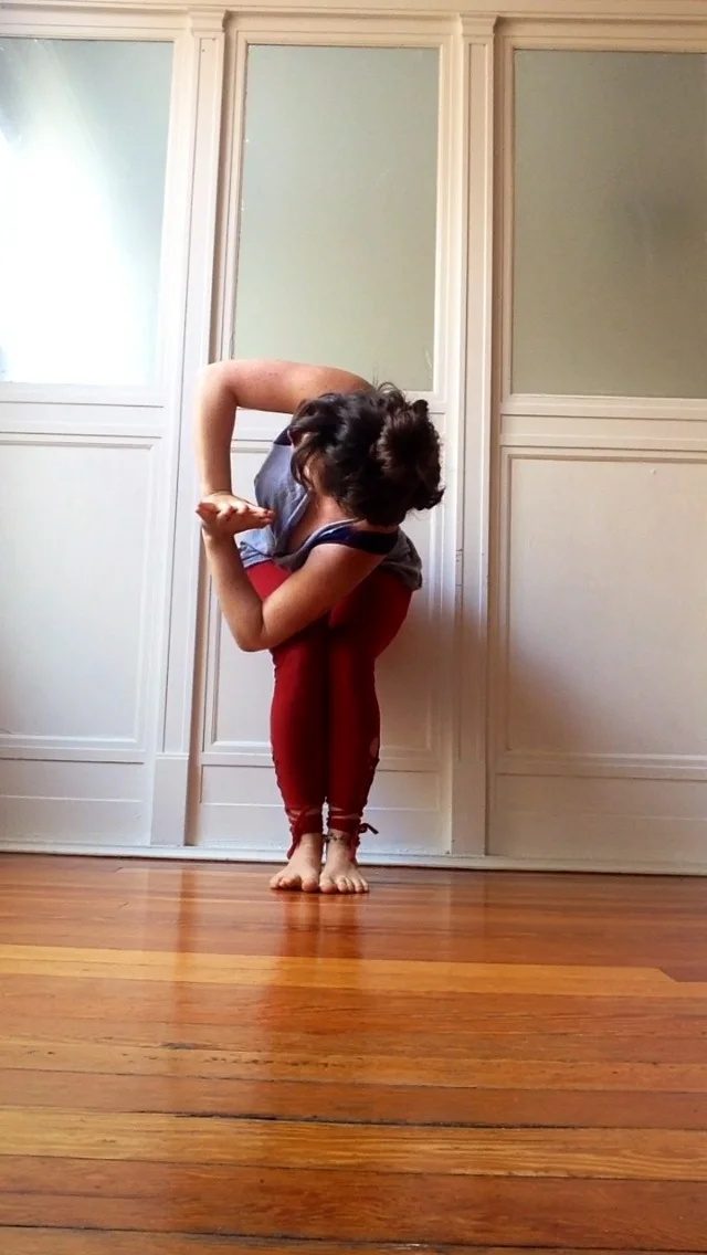 Start standing at the top of your mat. Bring your legs and feet together. Bend your knees and sink your hips like you're sitting in a chair. Lift your arms high on the inhale. Look down and make sure you can see all ten toes, aligning your hips with your heels. Hug the inner thighs together and slightly scoop the tailbone to engage the lower abdomen. Exhale, bring your palms together in front of your heart and twist to the right, hooking the left elbow to the outside of the right knee. Check to make sure the knees are in one line and continue to squeeze the inner thighs and keep the weight in your heels. Inhale to lengthen through the crown of the head and exhale to twist deeper, peeling your right shoulder back and opening through the chest. Press your palms together and breathe for five breaths before switching sides.