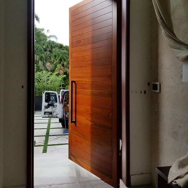 Hand made and hand finished solid #Ipe wood pivot front door with reinforced steel. 11βH x 5βW x 3βT and weighing in at over 800lbs. Using @fritsjurgens concealed pivot hinges. Manufactured and installed by #byblosgroup