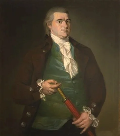 Offin Boardman in a painted portrait. A man in a brown coat, green velvety vest, and white shirt with frills at the wrists and chest holds a telescope that would be used on a sailing ship and looks directly at the viewer while facing slightly right