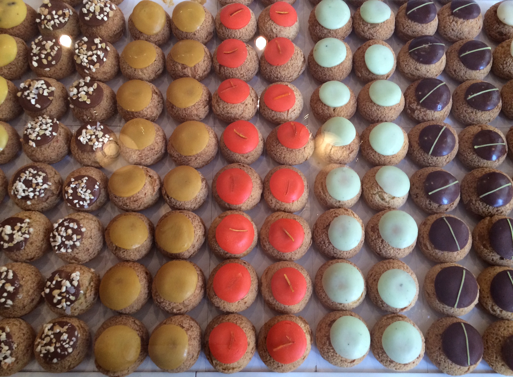 Profiteroles sold in Le Marais, Paris; filled with rose water or chocolate crème pat and sometimes gilded with gold leaf.