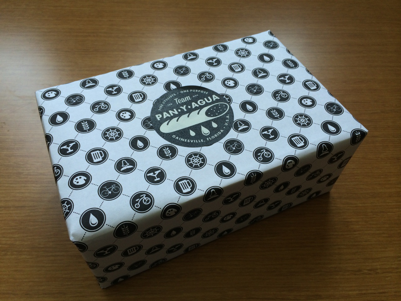 wrapped in custom design wrapping paper and topped with team sticker