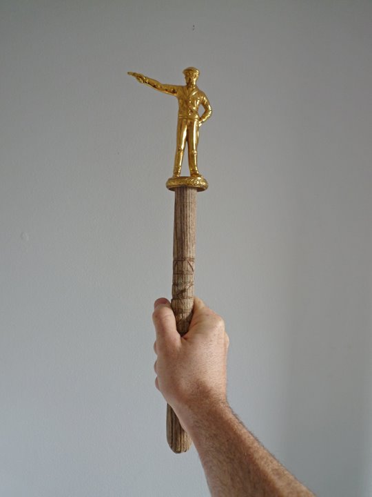 Shooting Stick (2008) golden enameled pot metal and wood 20 x 7 inches ( private collection )