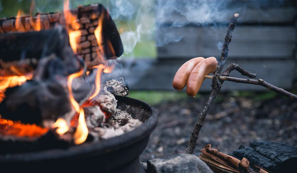 Sometimes I like to pre-cook the sausages by putting them near the fire for 15 minutes. This way they'll cook more evenly from the inside rather than just burning the skin.