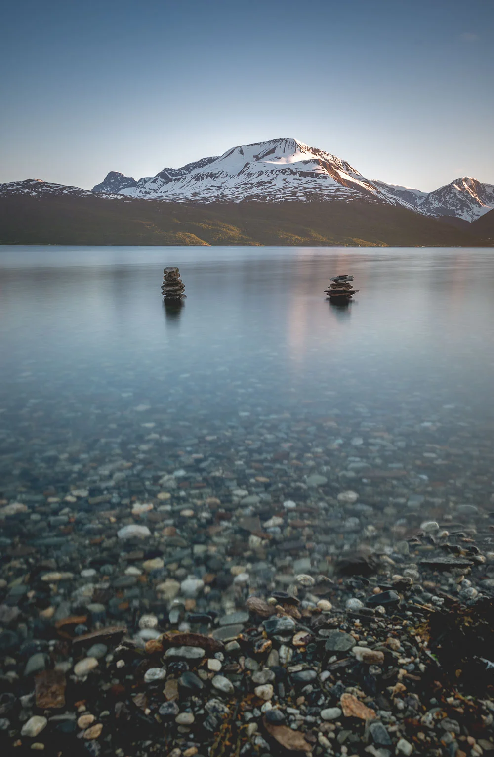 Two rock formations balanced in water in Skibotn.