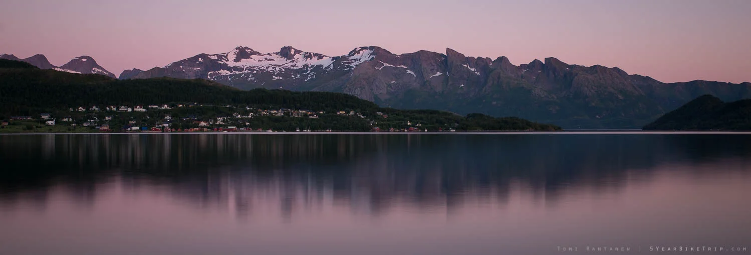 Town in Norway at dusk reflected from the fjord.