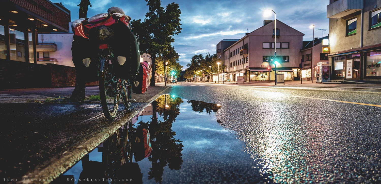Touring bike reflected at night off water in Steinkjer.