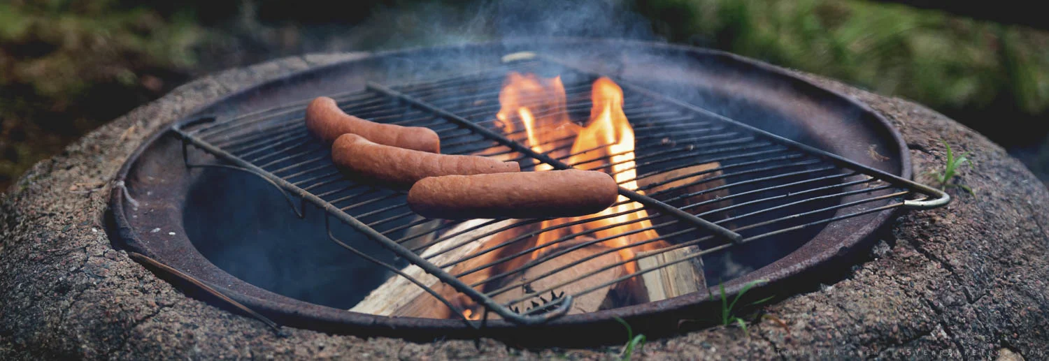 Frying sausages by the fire is a practically mandatory Finnish duty.