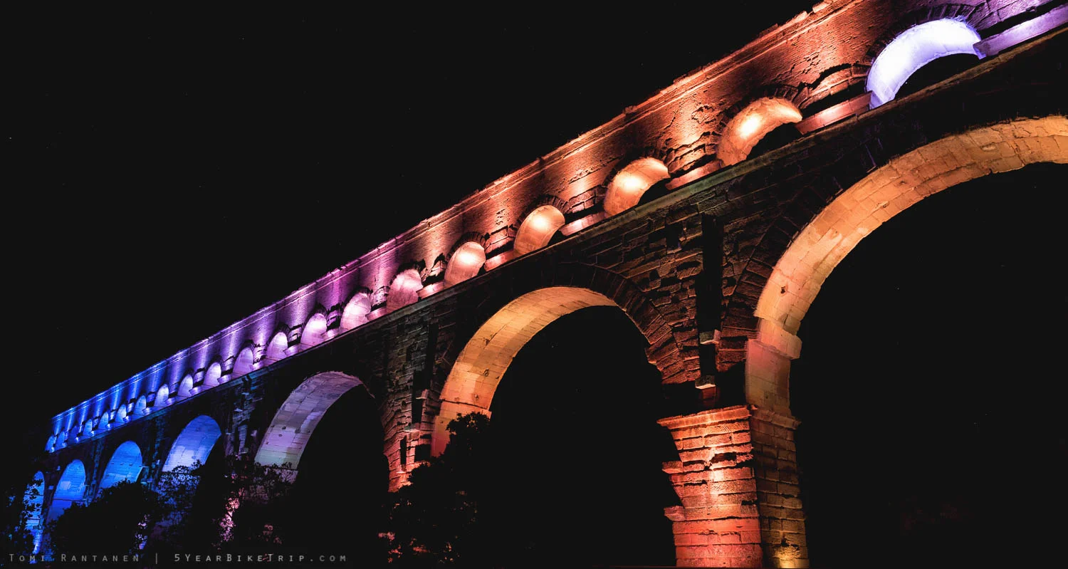The lights of Pont du Gard at night.