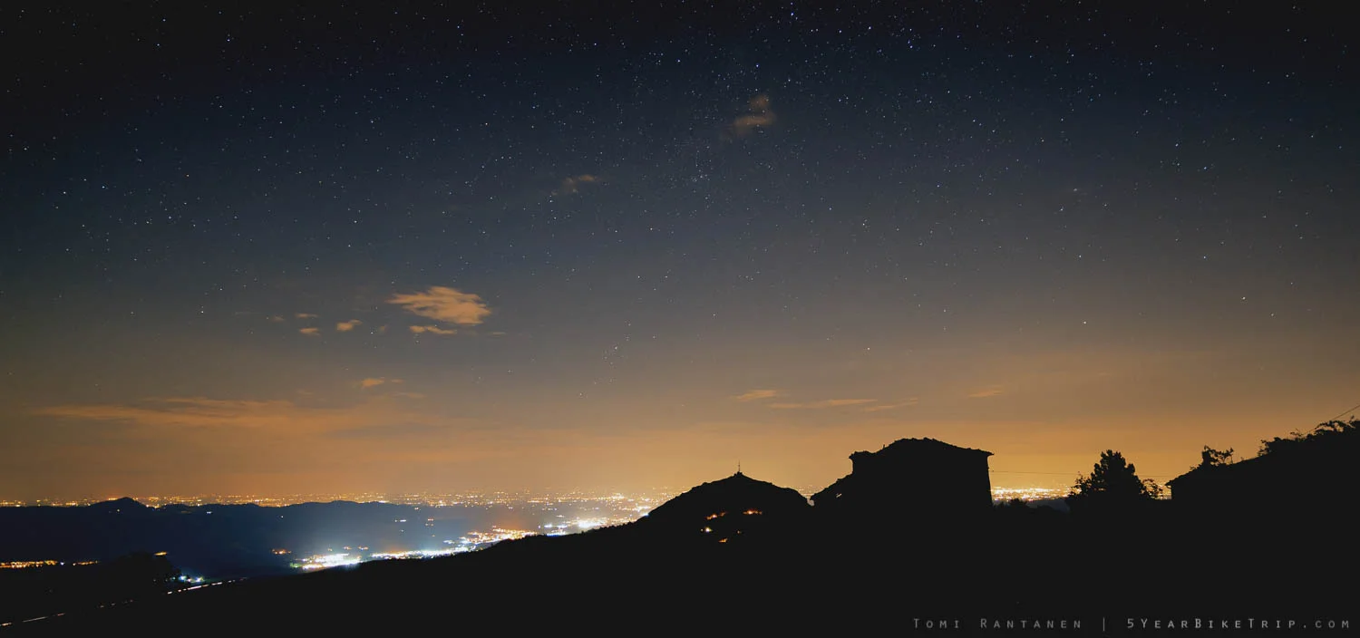 Silhouette of a villa and hill against the lights of some city I forgot. Maybe Parma?