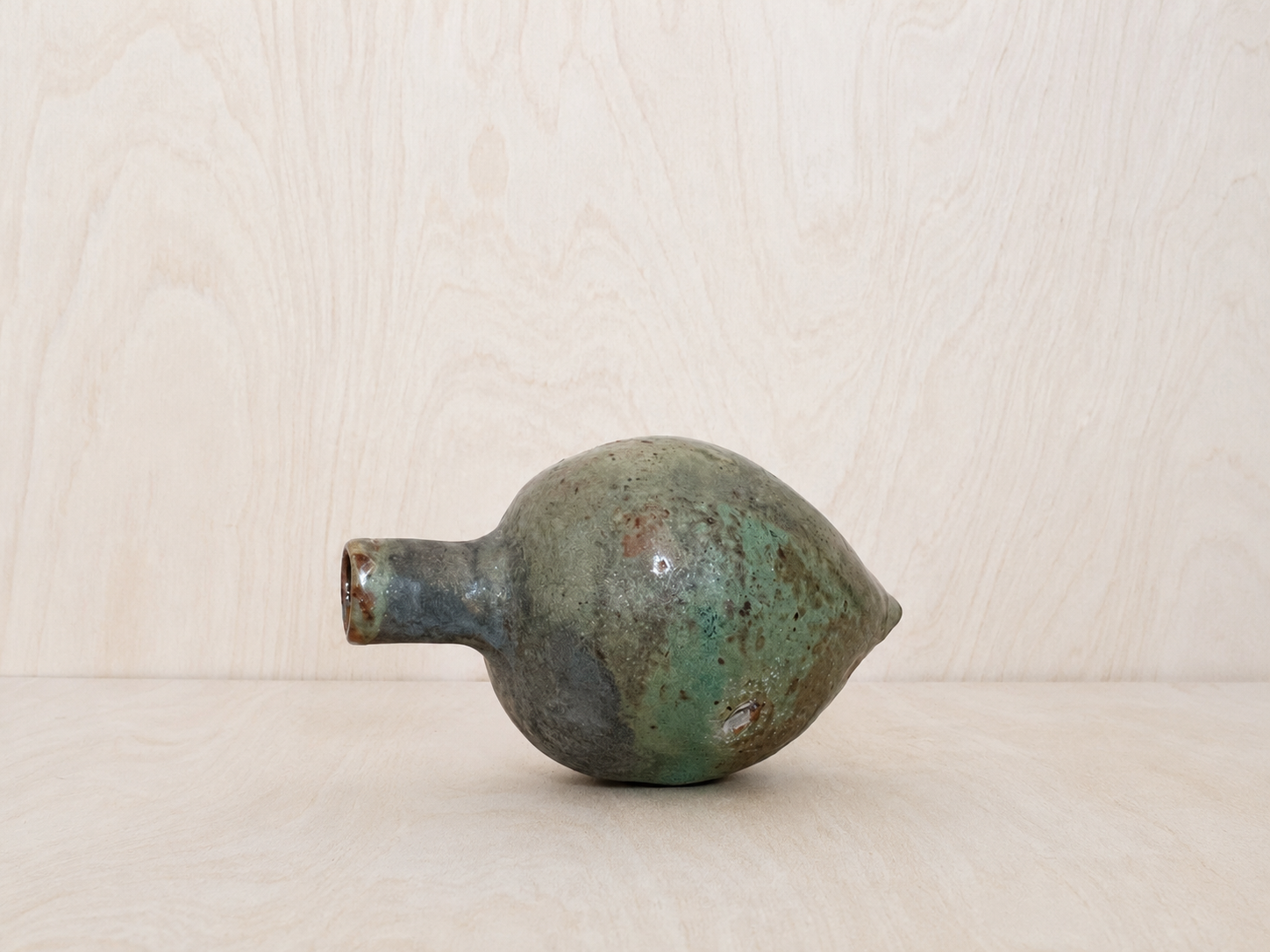 Hand-Built Ceramic Vessel on Pale Wood.png