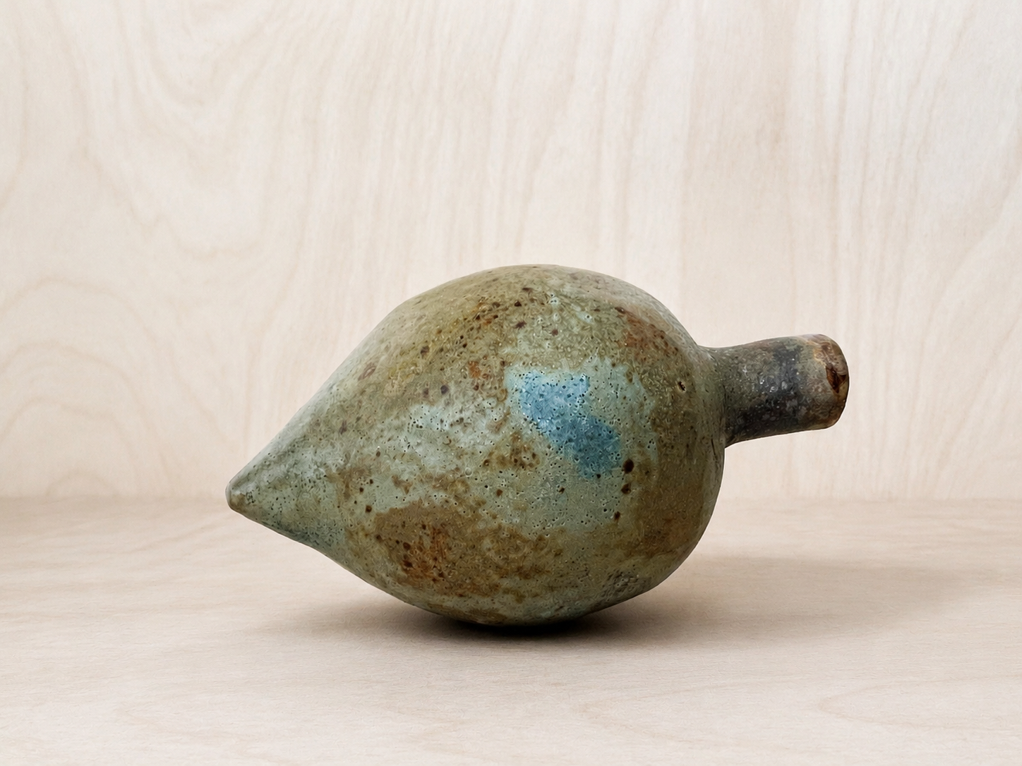 Hand-Built Ceramic Vessel on Pale Wood(1).png