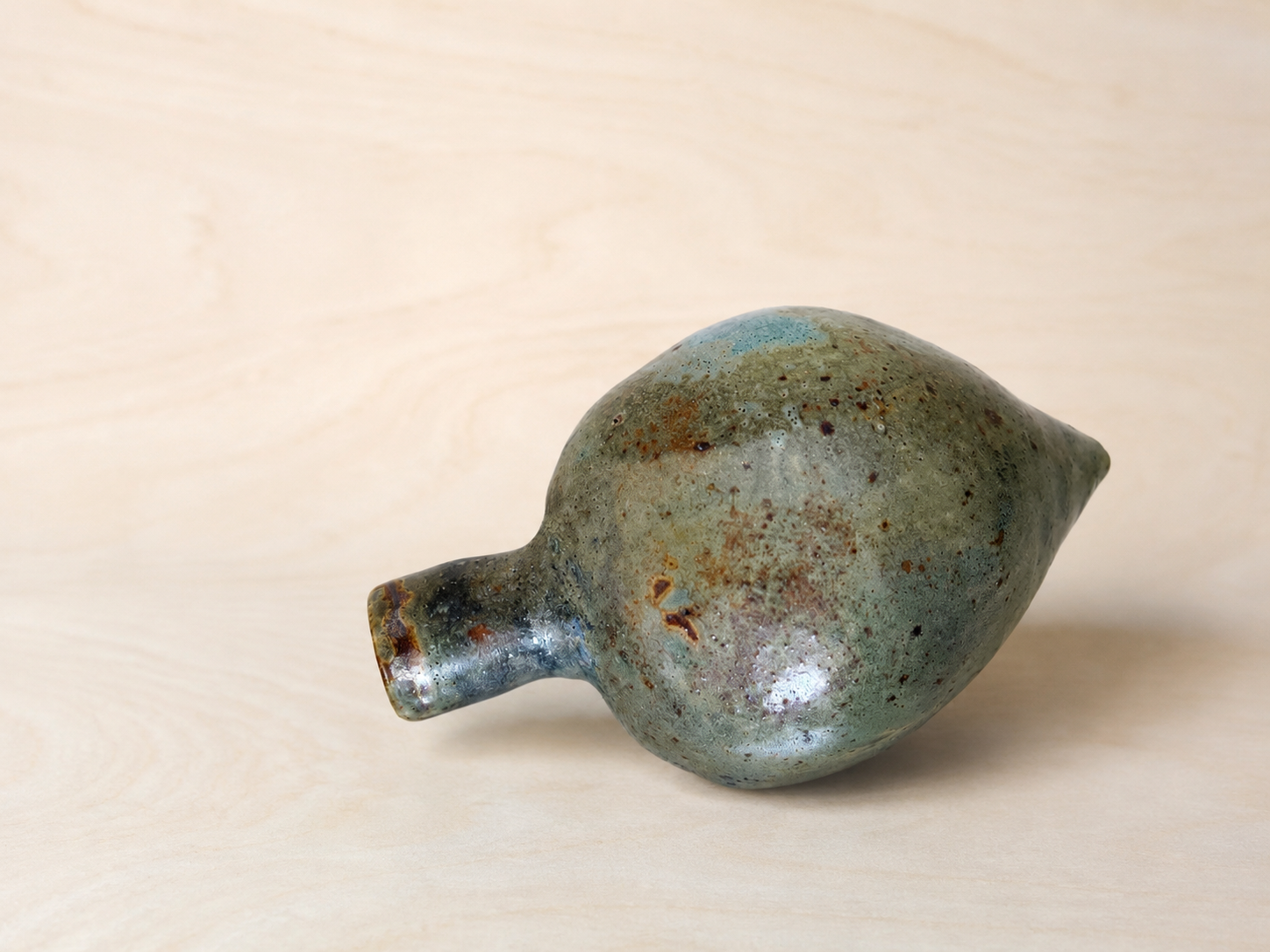Hand-Built Ceramic Vessel on Pale Wood(3).png