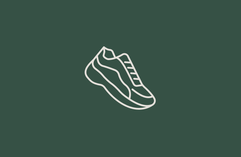 Line illustration of a sneaker on a green background.