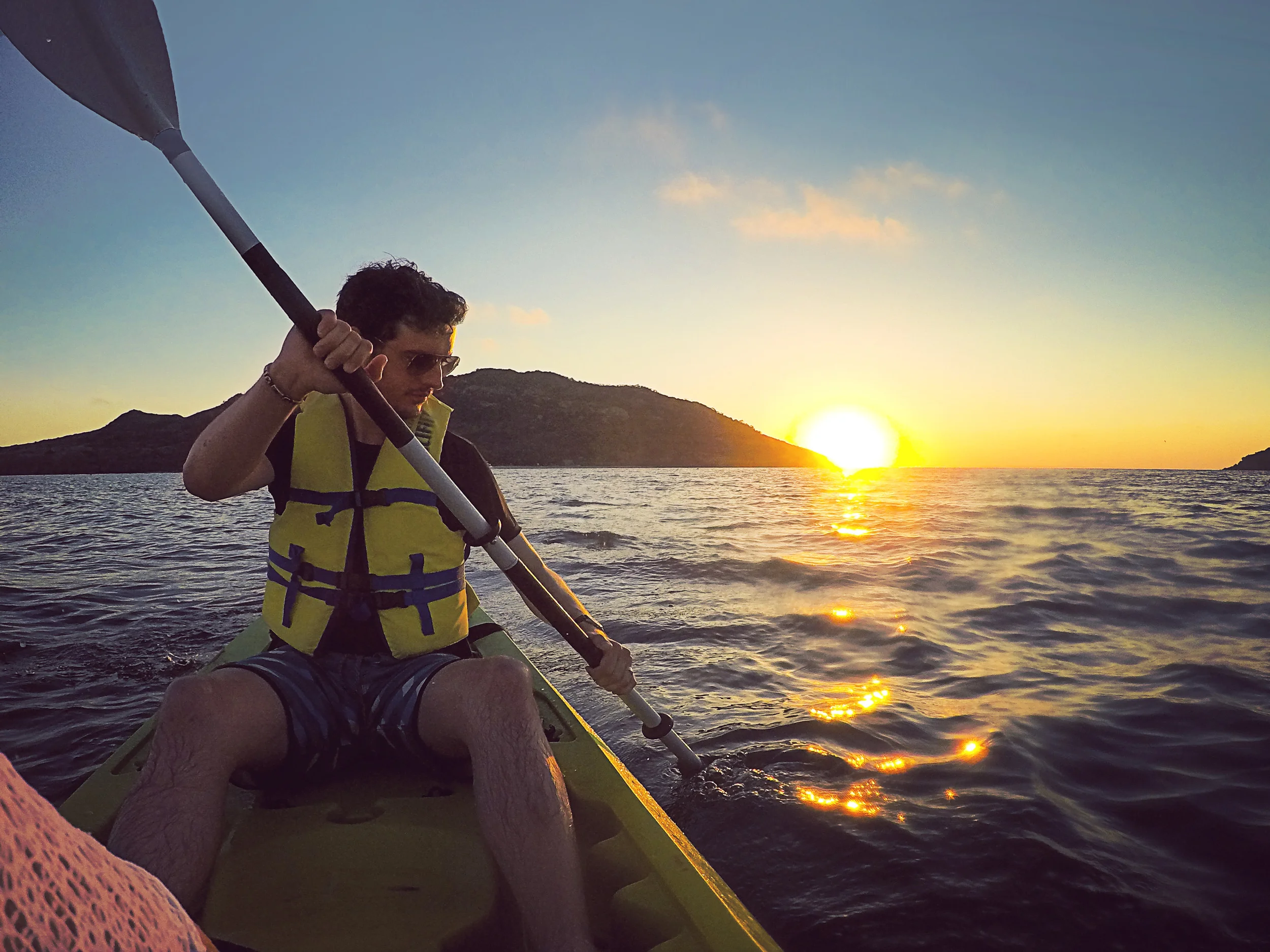 Day 59 - Mazatlan, Sinaloa, Mexico Our last day at the beach. We rented a kayak to go the small island nearby for the afternoon (see background on Day 56). It was a short 20 minute kayak each way and enjoyed the sunset on the water as we returned to shore. Cocos locos, two cute dogs and some hammocks greeted us at the island.