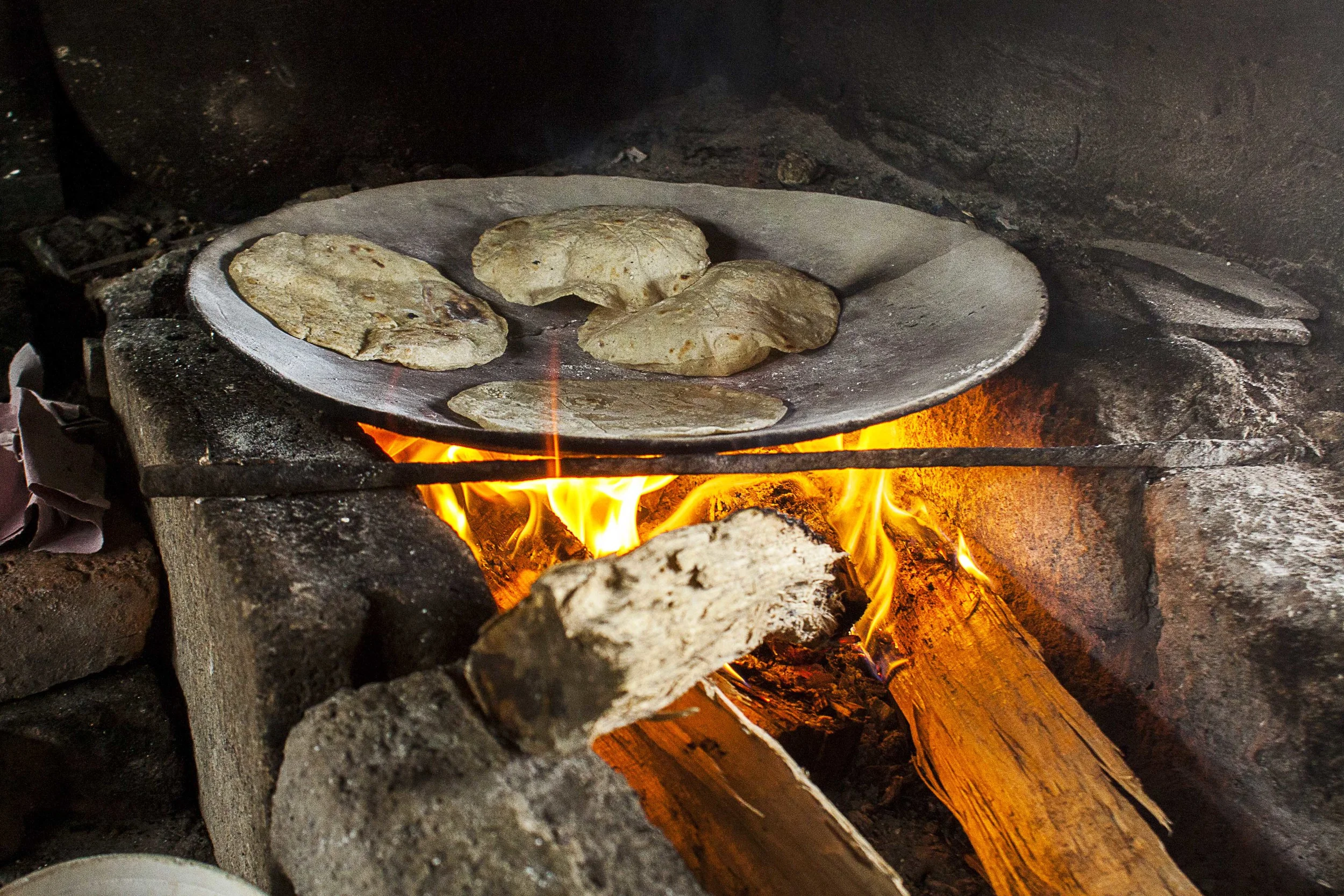 Day 118 - San Andres Tuxtla, Veracruz, Mexico Freshly hand made tortillas being made for my quesadillas. I wasn't even hungry but seeing how these tortillas fluff up in the wooden stove gave me a hint they would be delicious with the panela cheese filling. All for 10 pesos... Needles to say they were delicious.
